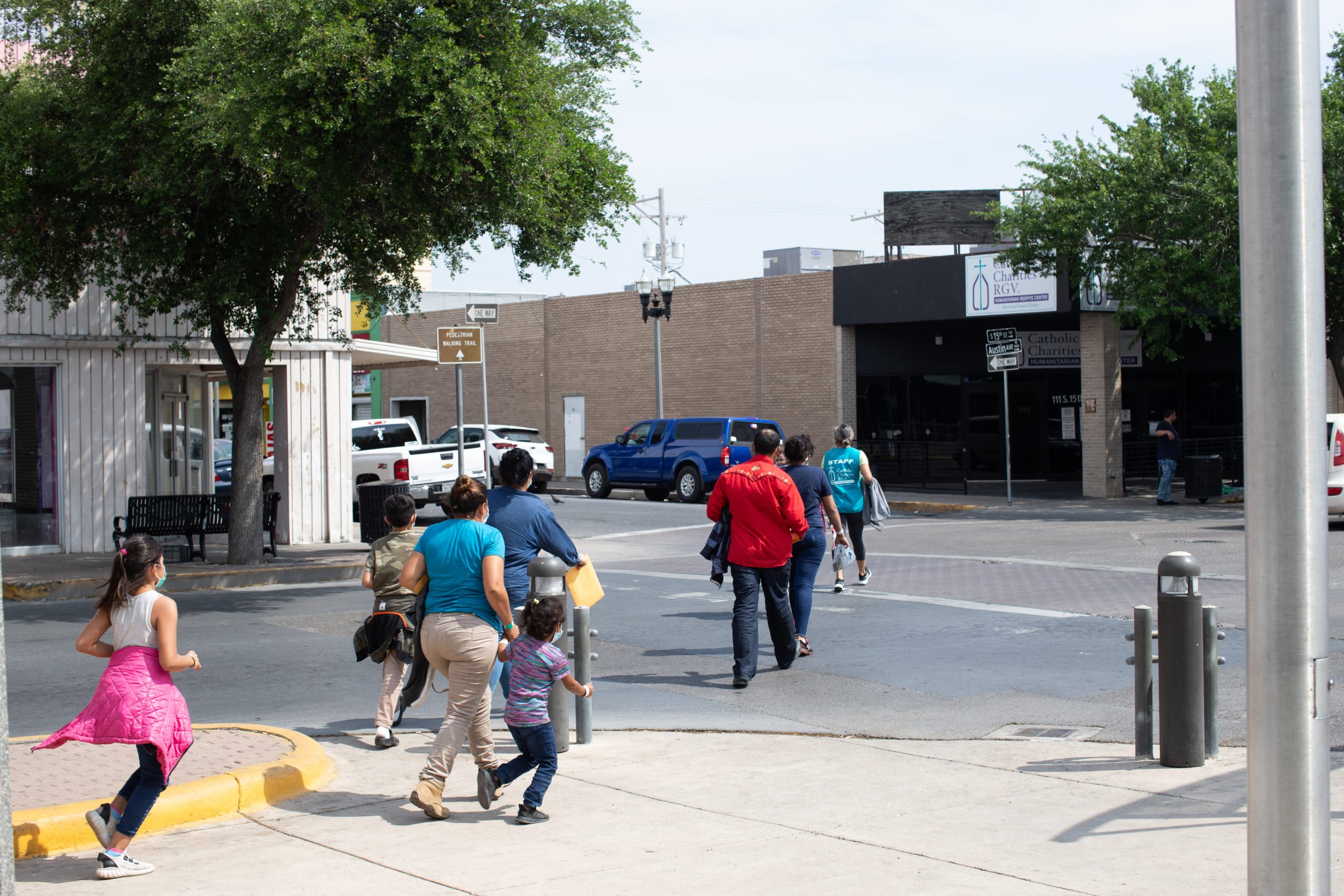 Migrants were escorted from a COVID-19 testing center to a humanitarian respite center operated by the Catholic Charities of the RGV in McAllen, Texas on March 27, 2021. (Kaylee Greenlee - Daily Caller News Foundation) 