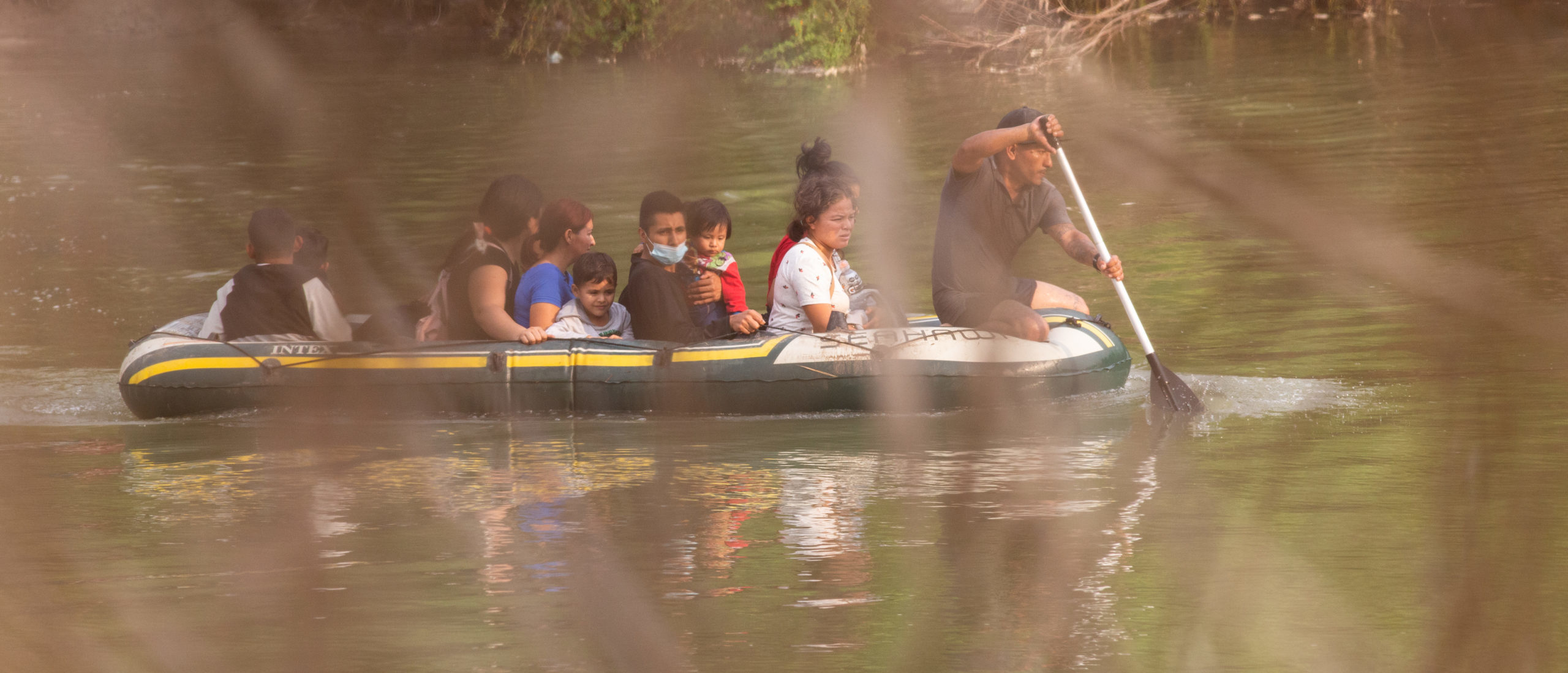 Smugglers use an inflatable raft to transport migrants across the Rio Grande River so they can illegally cross into the Rincon Village near McAllen, Texas, on March 24, 2021. (Kaylee Greenlee. - Daily Caller News Foundation)