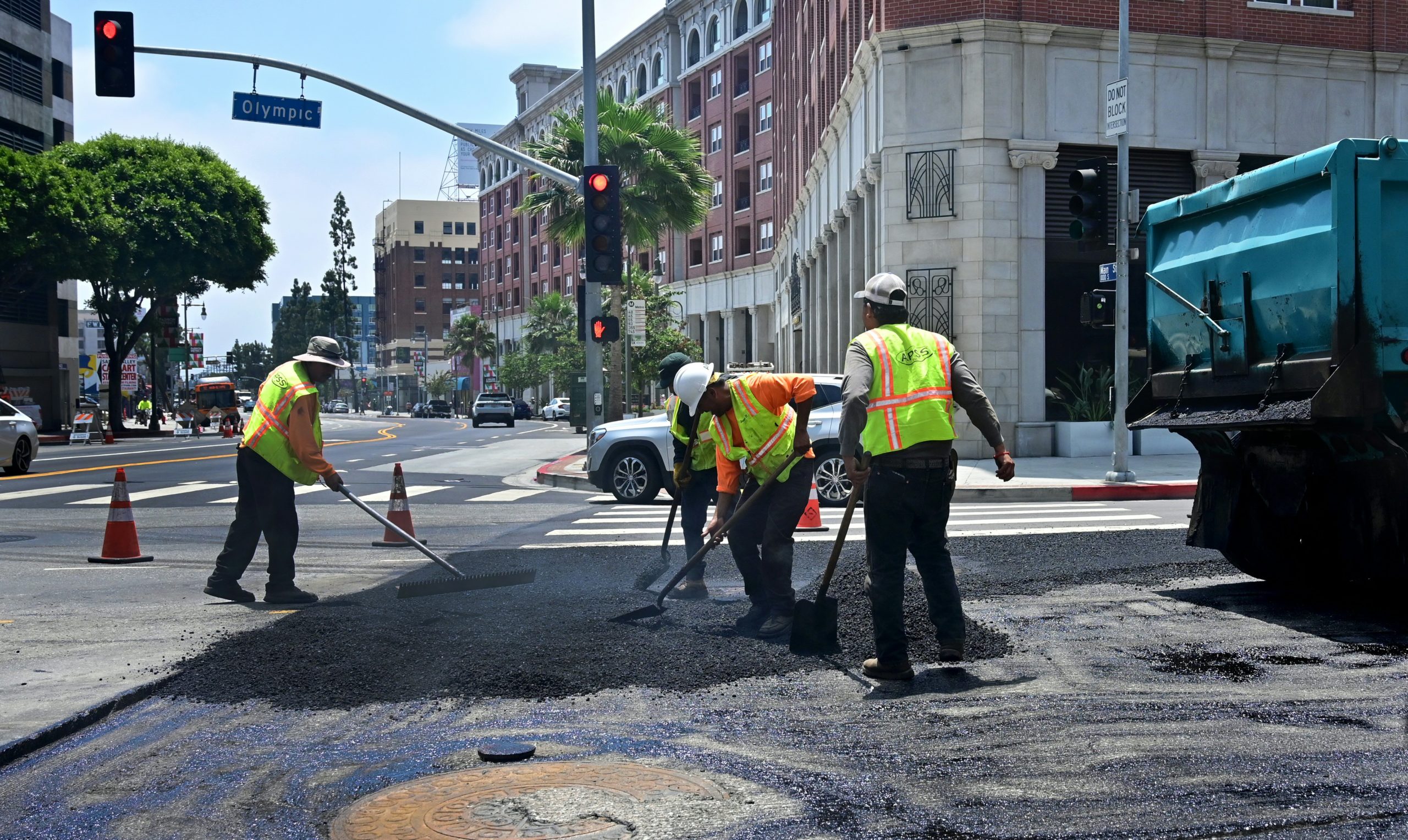 Workers resurface a road by pouring a new layer of asphalt in Los Angeles, California on June 24, 2019. (Frederic J. Brown/AFP via Getty Images)