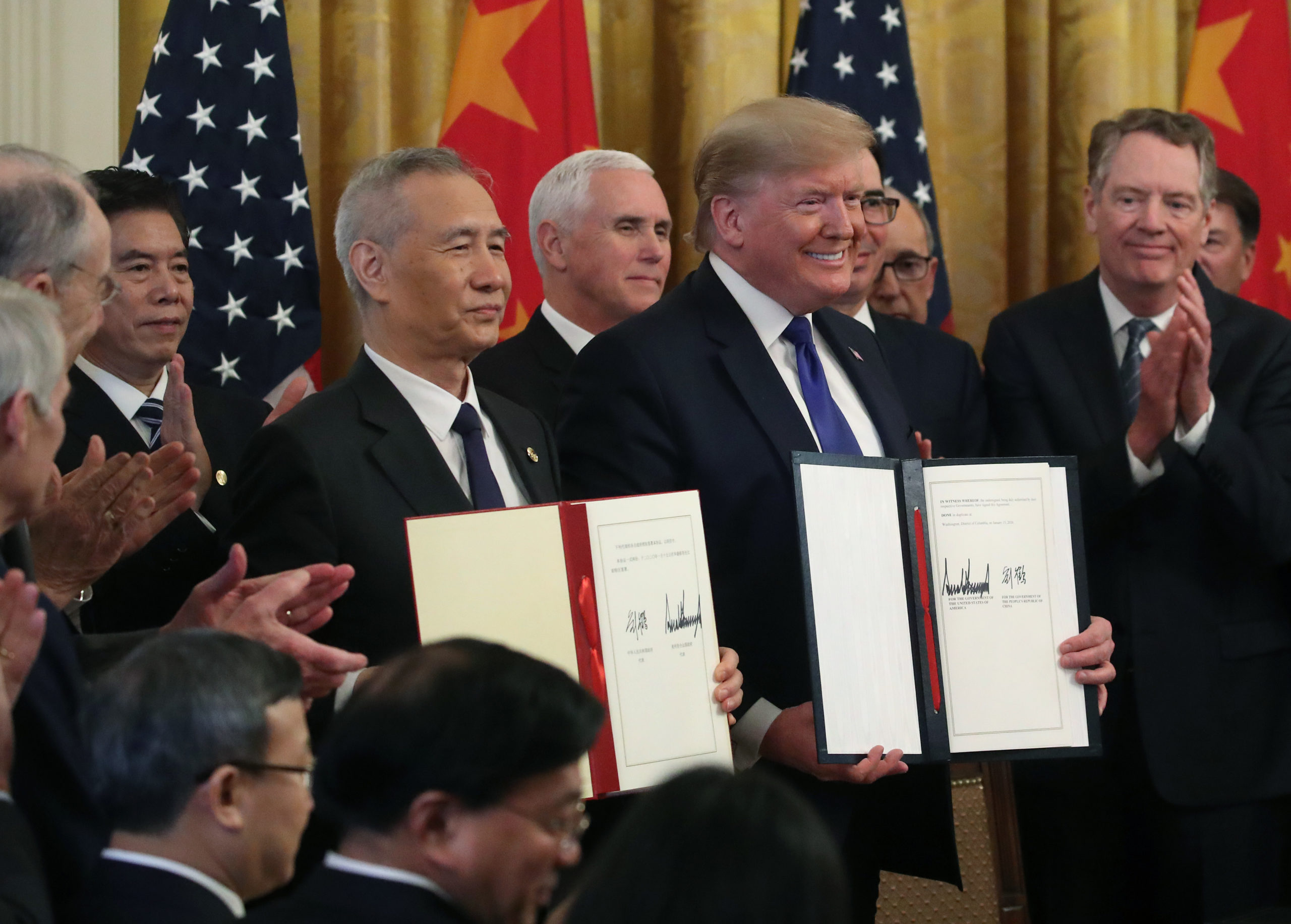 WASHINGTON, DC - JANUARY 15: U.S. President Donald Trump and Chinese Vice Premier Liu He, hold up signed agreements of phase 1 of a trade deal between the U.S. and China, in the East Room at the White House, on January 15, 2020 in Washington, DC. Phase 1 is expected to cut tariffs and promote Chinese purchases of U.S. farm, and manufactured goods while addressing disputes over intellectual property. (Photo by Mark Wilson/Getty Images)