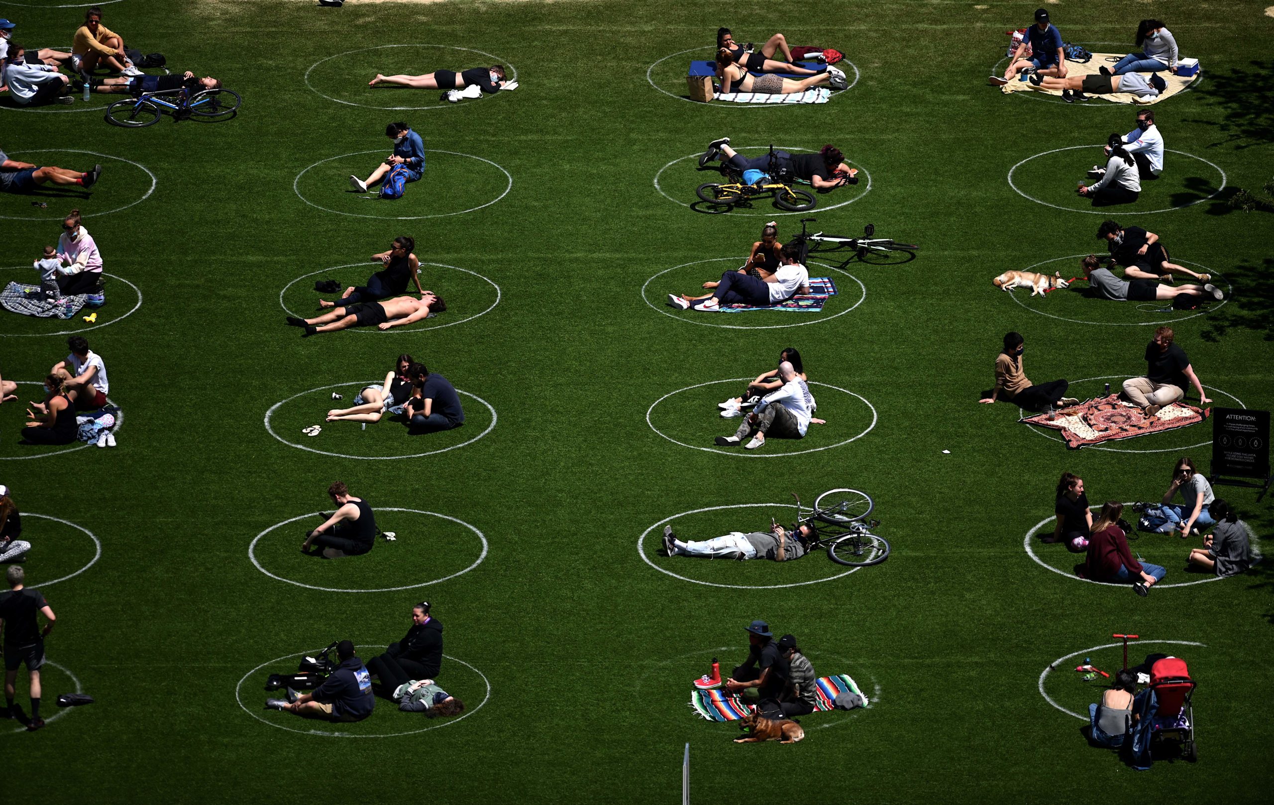 People are seen social distancing in white circles in New York City last year. (Johannes Eisele/AFP via Getty Images)
