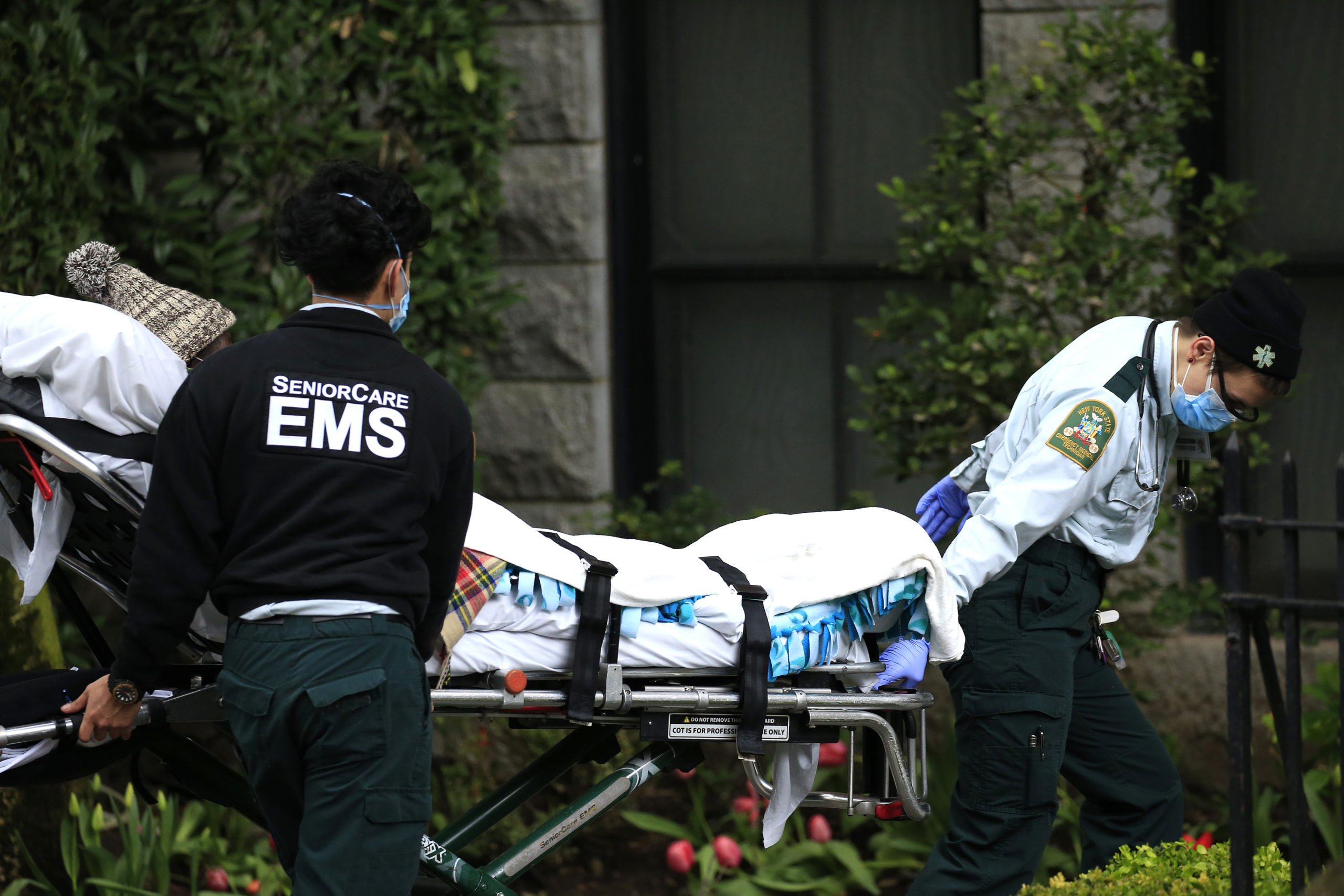 Emergency Medical Service workers unload a patient out of their ambulance at the Cobble Hill Health Center on April 18, 2020 in the Brooklyn borough of New York City. The nursing home recorded dozens of COVID-19 reported deaths. (Justin Heiman/Getty Images)