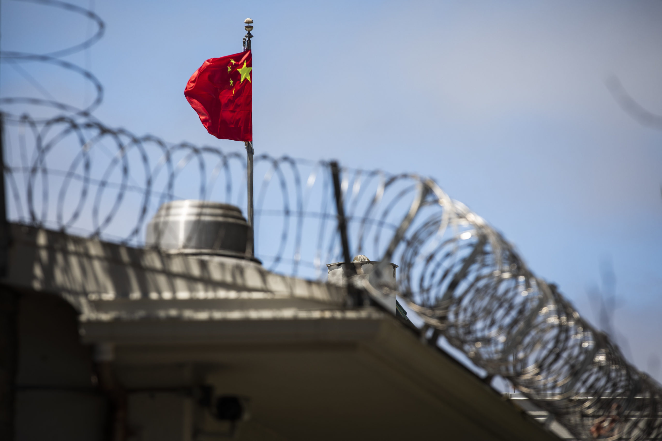 The flag of the People's Republic of China flies behind barbed wire at the Consulate General of the People's Republic of China in San Francisco, California on July 23, 2020. - The US Justice Department announced July 23, 2020 the indictments of four Chinese researchers it said lied about their ties to the People's Liberation Army, with one escaping arrest by taking refuge in the country's San Francisco consulate. (Photo by Philip Pacheco / AFP) (Photo by PHILIP PACHECO/AFP via Getty Images)