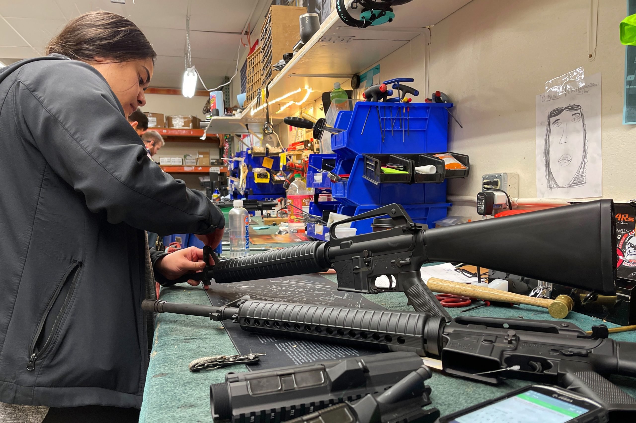 A worker assembles AR-15 style rifles at Davidson Defense in Orem, Utah on February 4, 2021. - Gun merchants sold more than 2 million firearms in January, a 75% increase over the estimated 1.2 million guns sold in January 2020, according to the National Shooting Sports Federation, a firearms industry trade group. The FBI said it conducted a record 4.3 million background checks in January. If that pace continues, the bureau will complete more than 50 million gun-related background checks by the end of the year, shattering the current record set in 2020, according to a new report from Bespoke Investment Group. (Photo by GEORGE FREY / AFP) (Photo by GEORGE FREY/AFP via Getty Images)