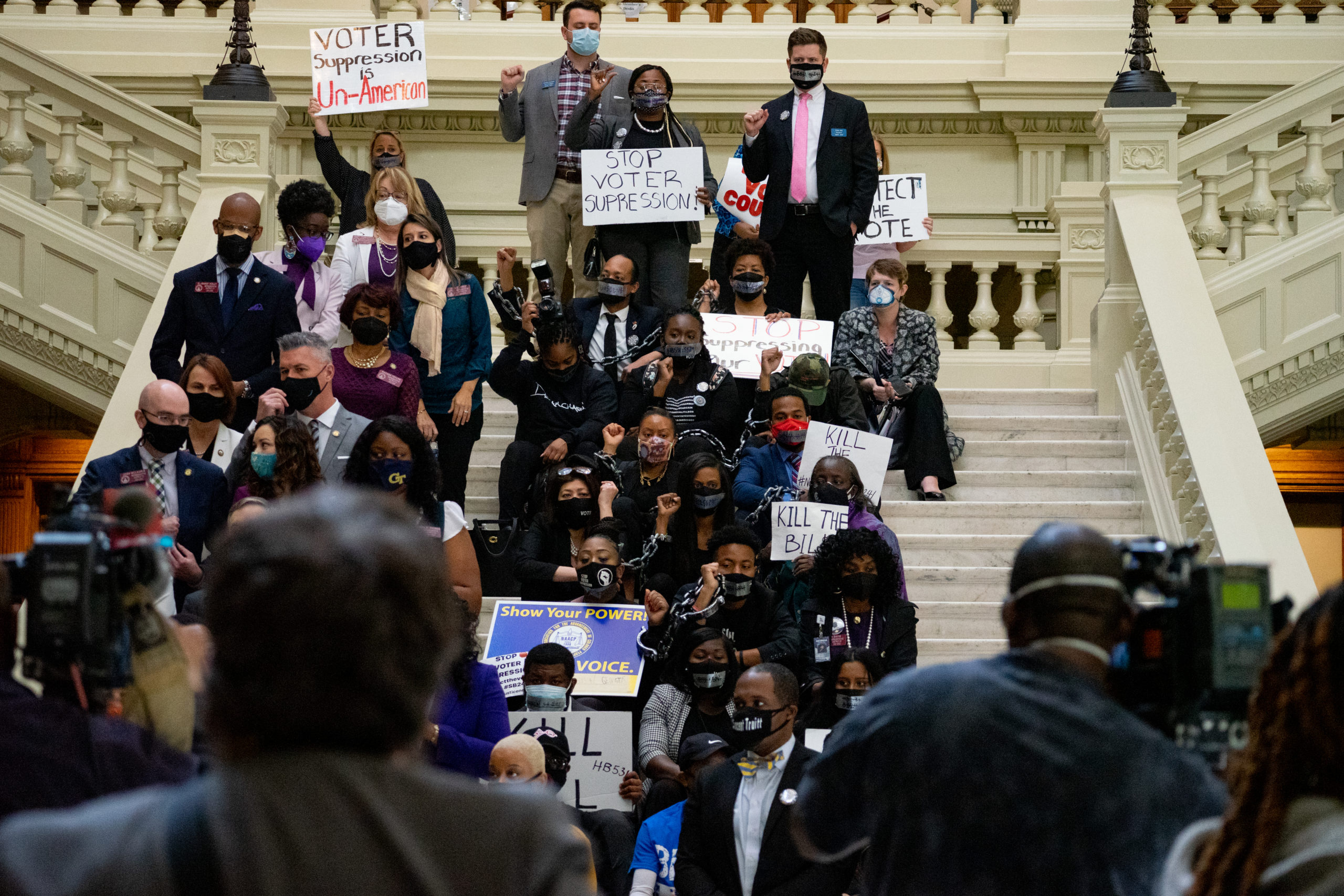 Demonstrators hold a sit-in inside of Georgia Capitol building in opposition of a Republican bill that would restrict early voting hours, remove drop boxes, and require the use of a government ID when voting by mail. (Photo by Megan Varner/Getty Images)
