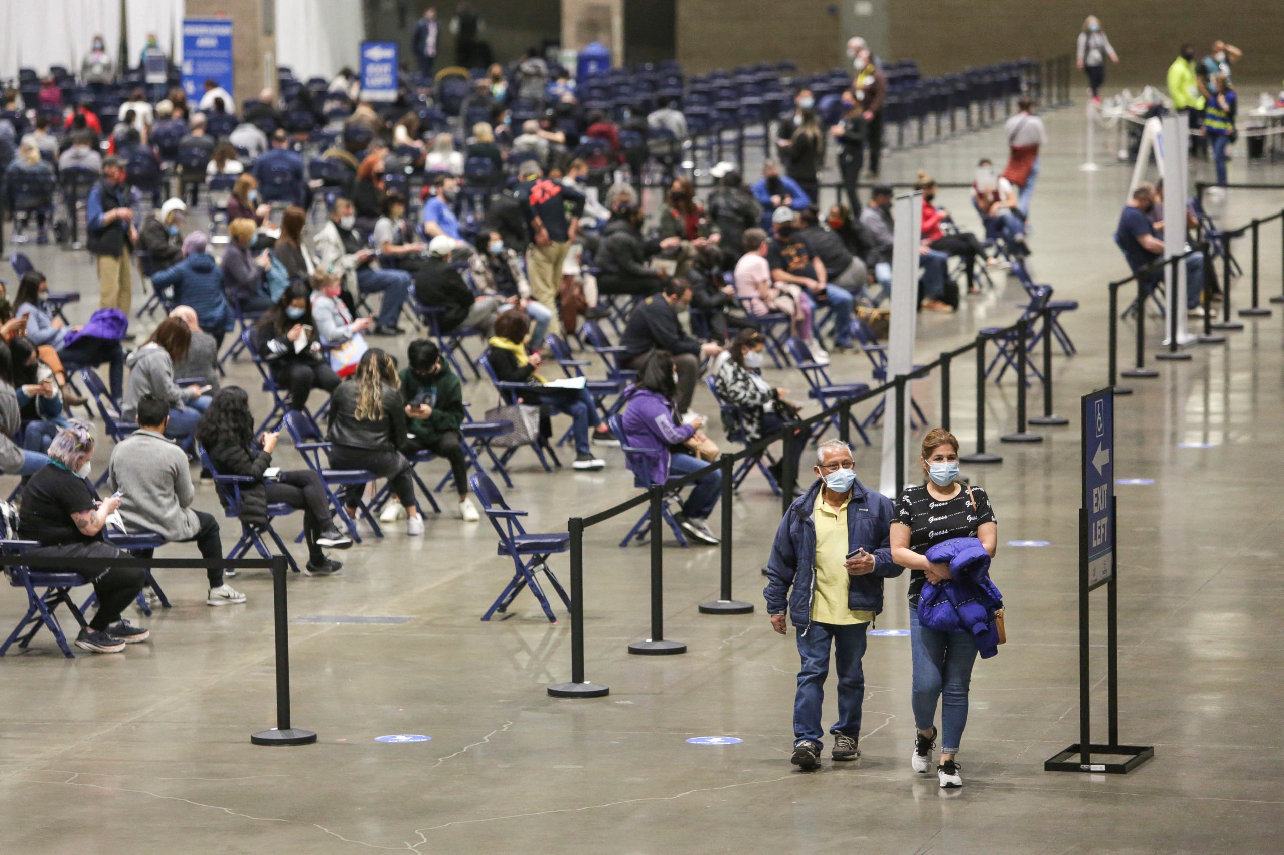 People depart after receiving the Pfizer Covid-19 vaccine in Seattle, Washington on March 13, 2021. (JASON REDMOND/AFP via Getty Images)