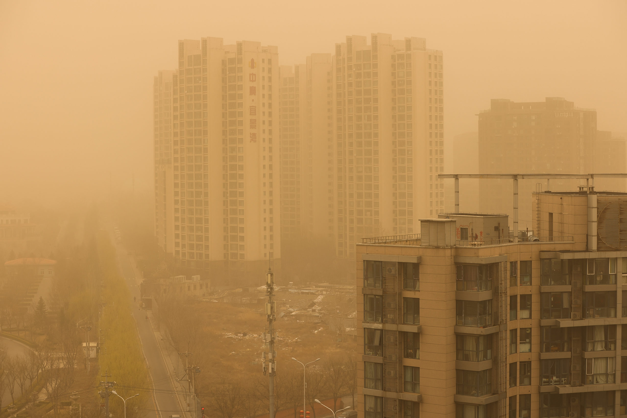 BEIJING, CHINA - MARCH 15: Buildings are seen during a sandstorm on March 15, 2021 in Beijing, China. The Chinese capital and the northern parts of the country was hit with a sandstorm on Monday, sending air quality indexes of PM 2.5 and PM 10 ratings into the thousands and cancelling flights. (Photo by Getty Images)