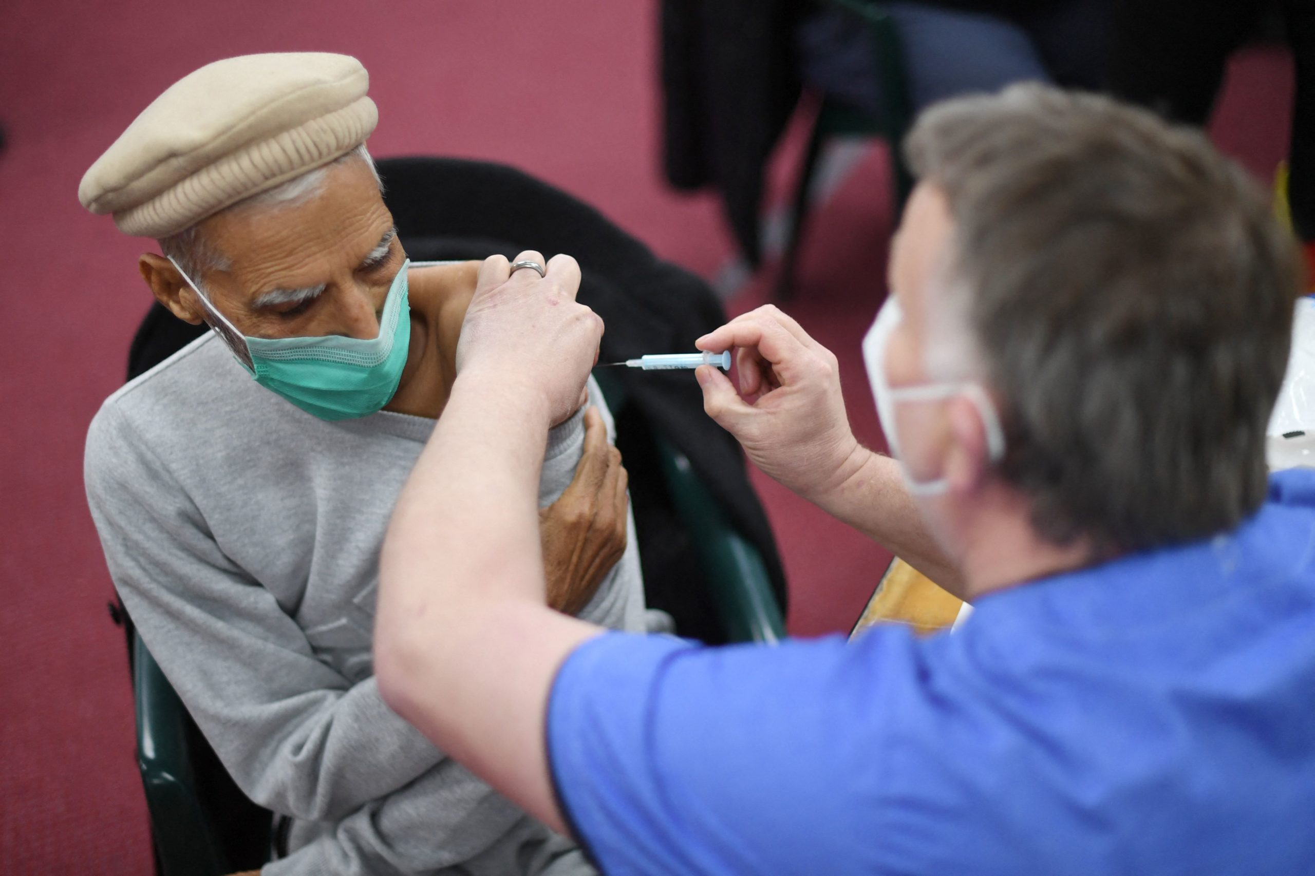 A health worker administers a dose of the AstraZeneca vaccine at a coronavirus vaccination location in London on Tuesday. (Daniel Leal-Olivas/AFP via Getty Images)