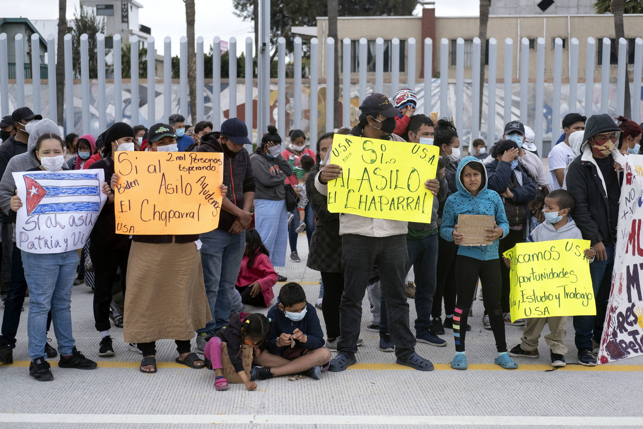 Migrants and asylum seekers demonstrate at the San Ysidro crossing port asking US authorities to allow them to start their migration process in Tijuana, Baja California state, Mexico on March 23, 2021. (GUILLERMO ARIAS/AFP via Getty Images)