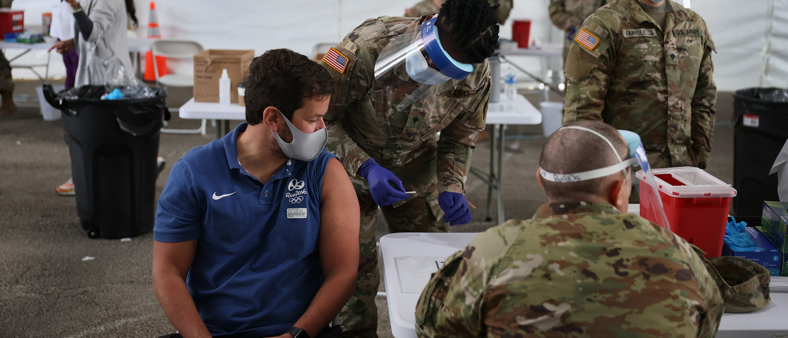 An Army soldier from the 2nd Armored Brigade Combat Team, 1st Infantry Division, helps give COVID-19 vaccinations at the Miami Dade College North Campus on March 09, 2021. (Joe Raedle/Getty Images)