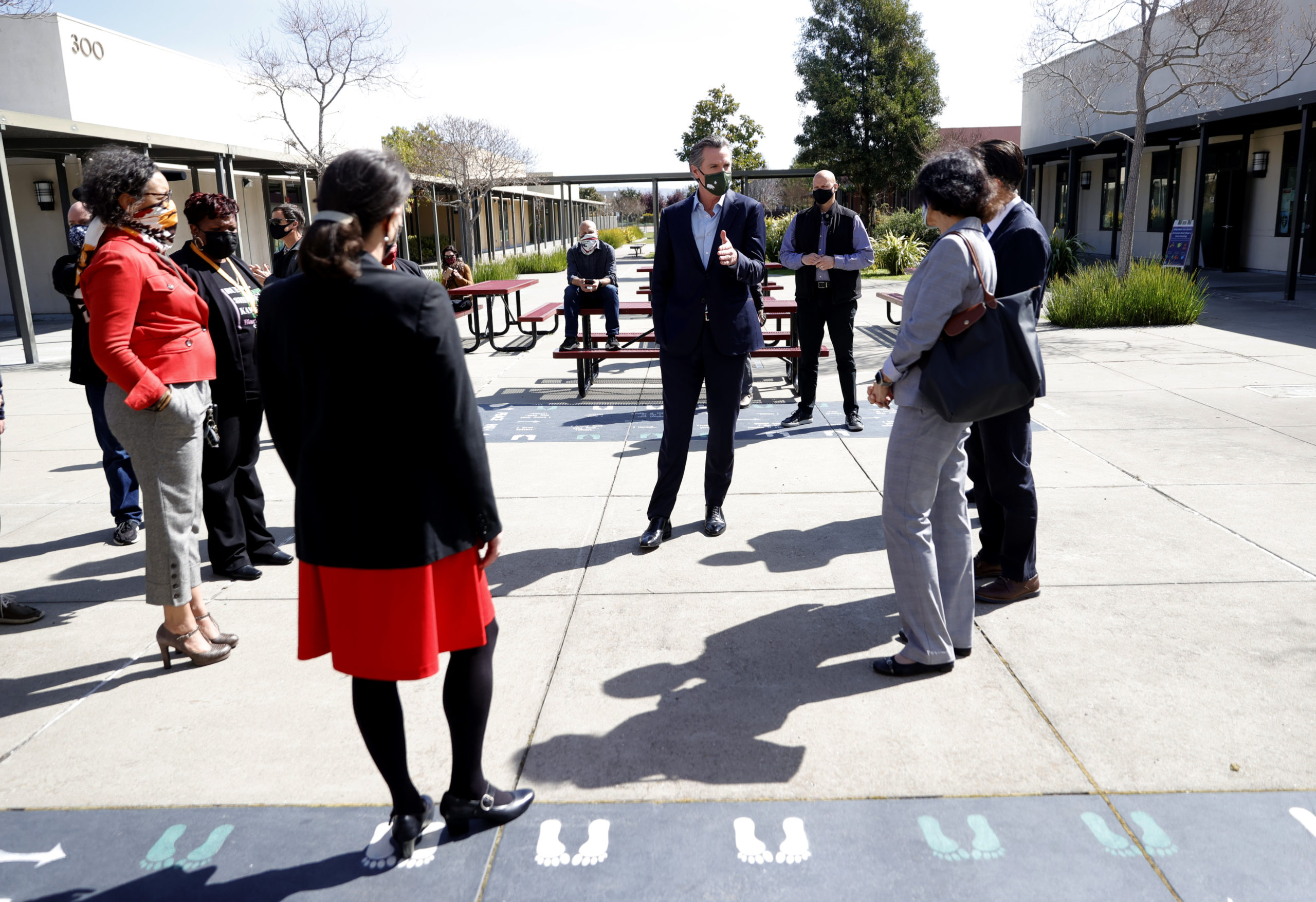 California Gov. Gavin Newsom talks with teachers and local officials on Tuesday in Alameda, California. (Justin Sullivan/Getty Images)