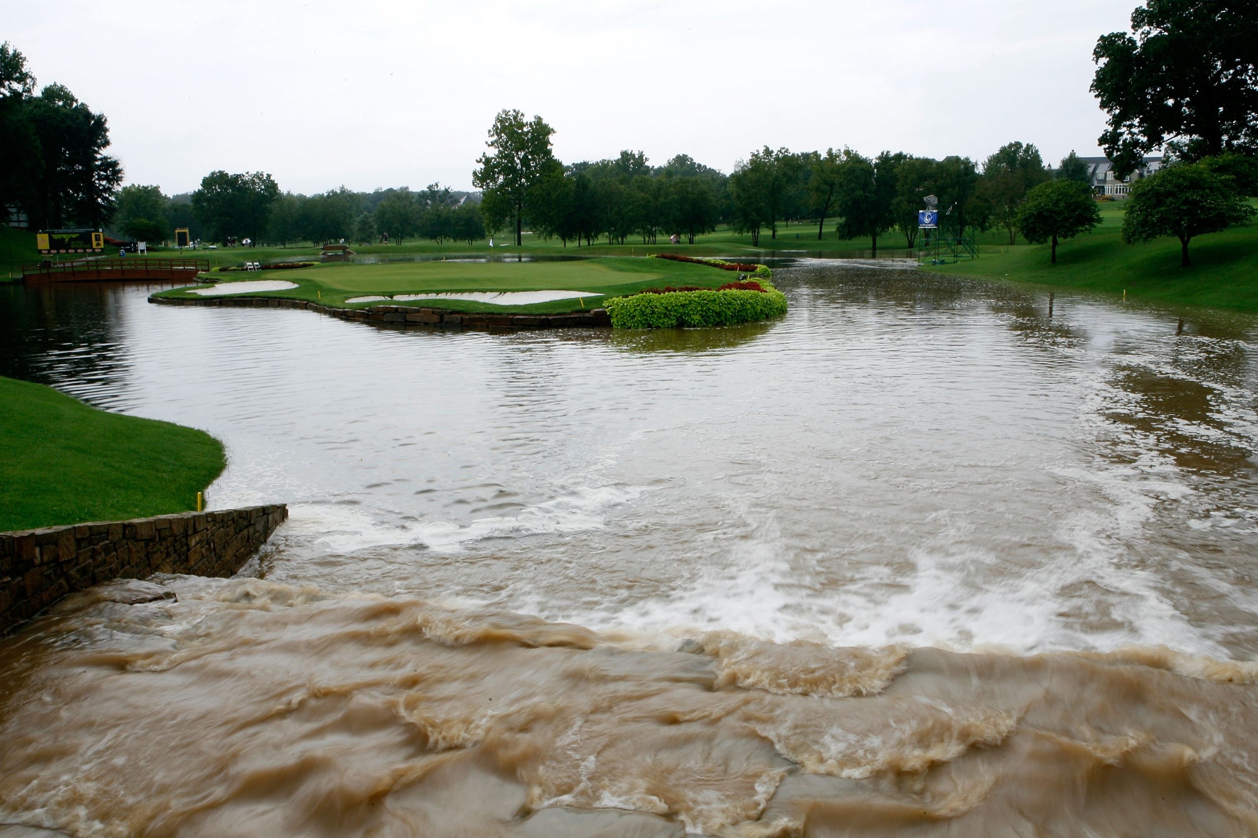 ROGERS, AR - SEPTEMBER 08: Water flows rapidly into the pond around the 15th green after play was suspended for the day at 10:49am cst during the second round of the 2007 LPGA NW Arkansas Championship presented by John Q. Hammons at Pinnacle Country Club on September 8, 2007 in Rogers, Arkansas. (Photo by Kevin C. Cox/Getty Images)