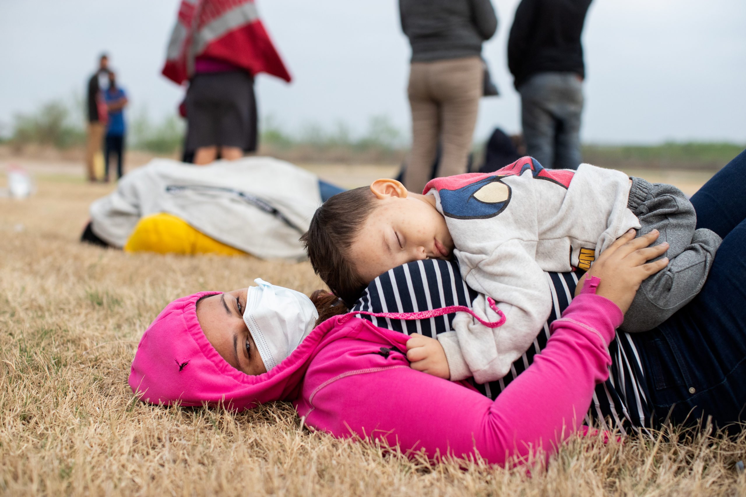 Illegal migrants wait on the side of a public road to be processed and taken to Customs and Border Protection facilities in La Joya, Texas on March 27, 2021. (Kaylee Greenlee - Daily Caller News Foundation)