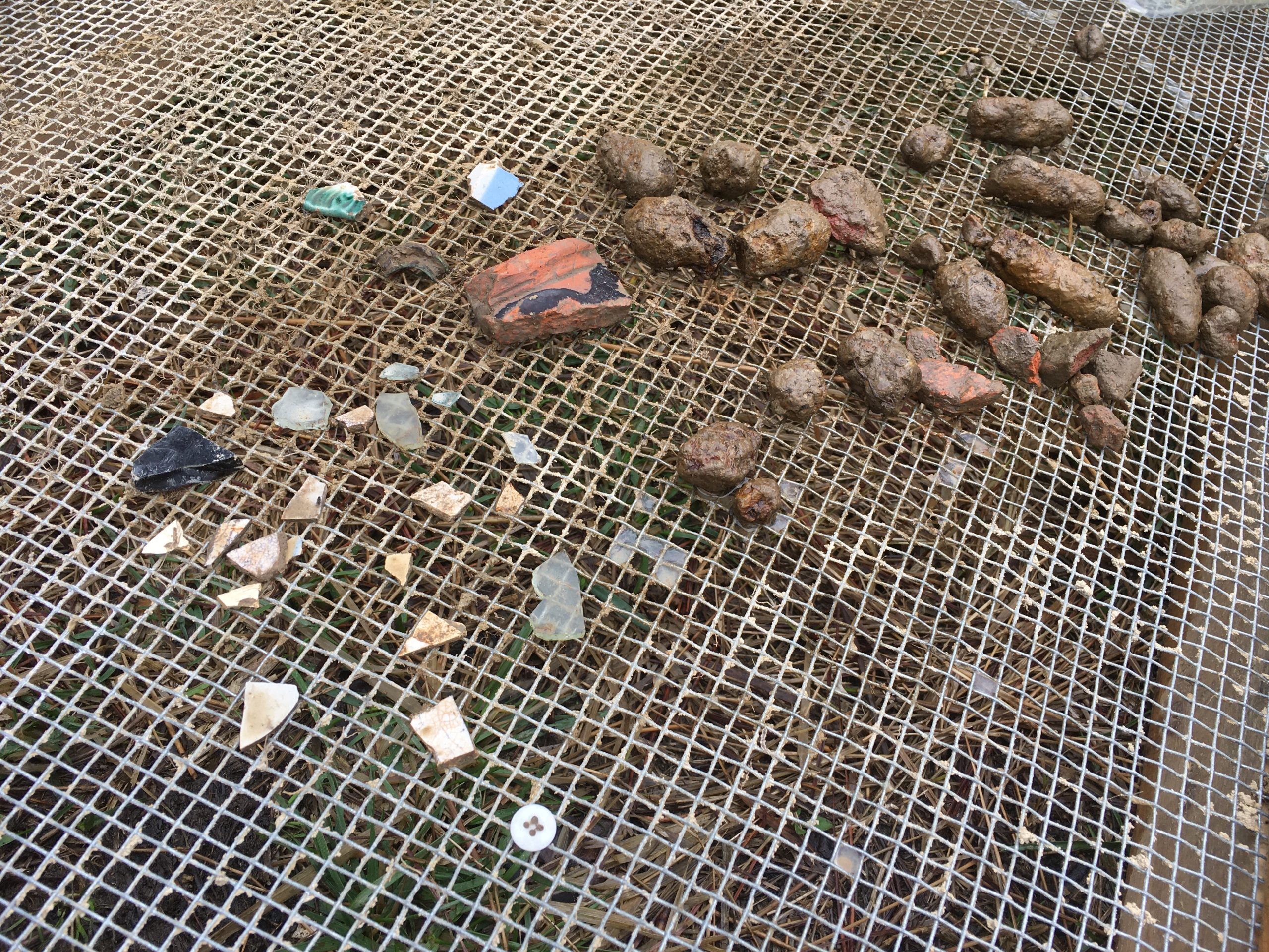 Artifacts found at Ben Ross' homesite in the Blackwater National Wildlife Refuge include a button, bits of pottery, glass and nails [Photo credit: Maryland Department of Transportation]