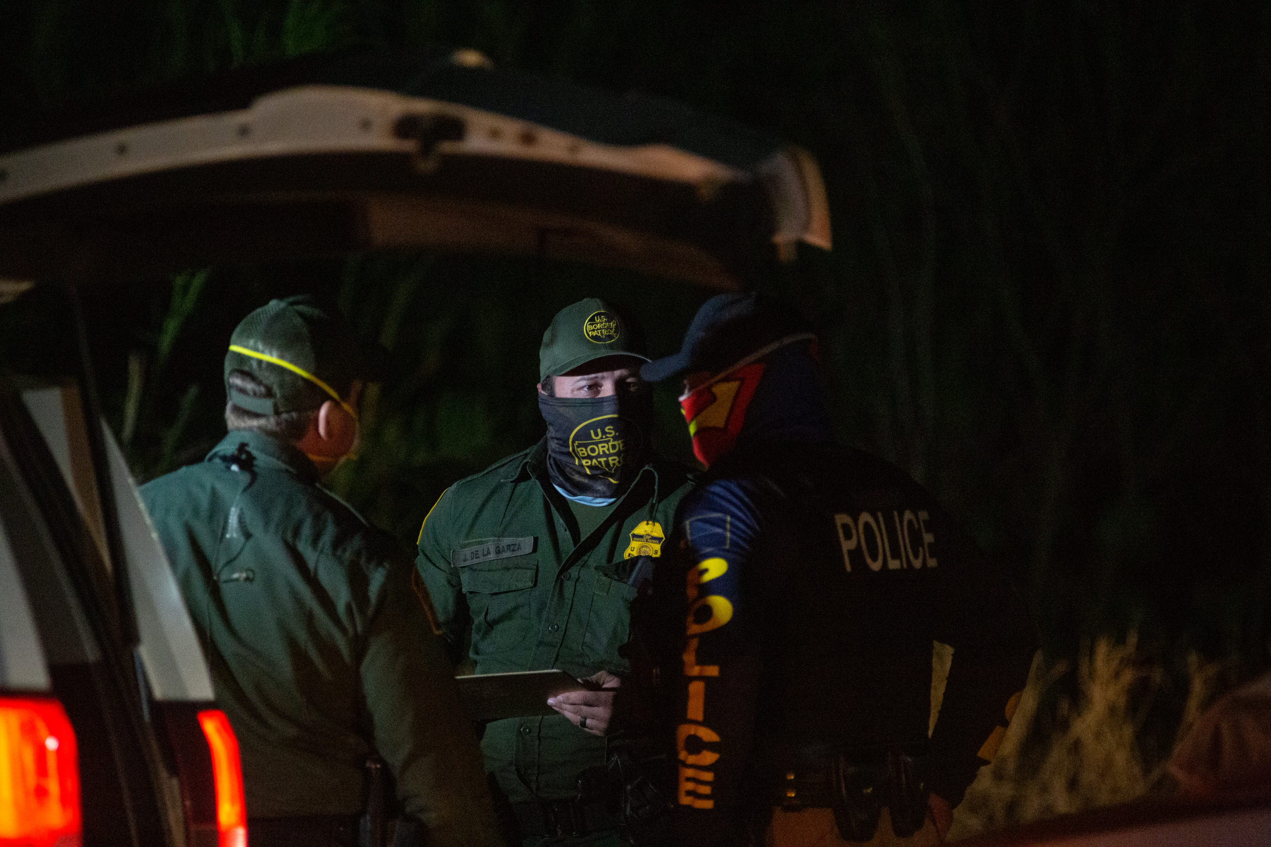 Customs and Border Protection officials work on processing groups of migrants arriving illegally in the U.S. in the middle of the night on March 26, near La Joya, Texas. (Kaylee Greenlee - Daily Caller News Foundation)