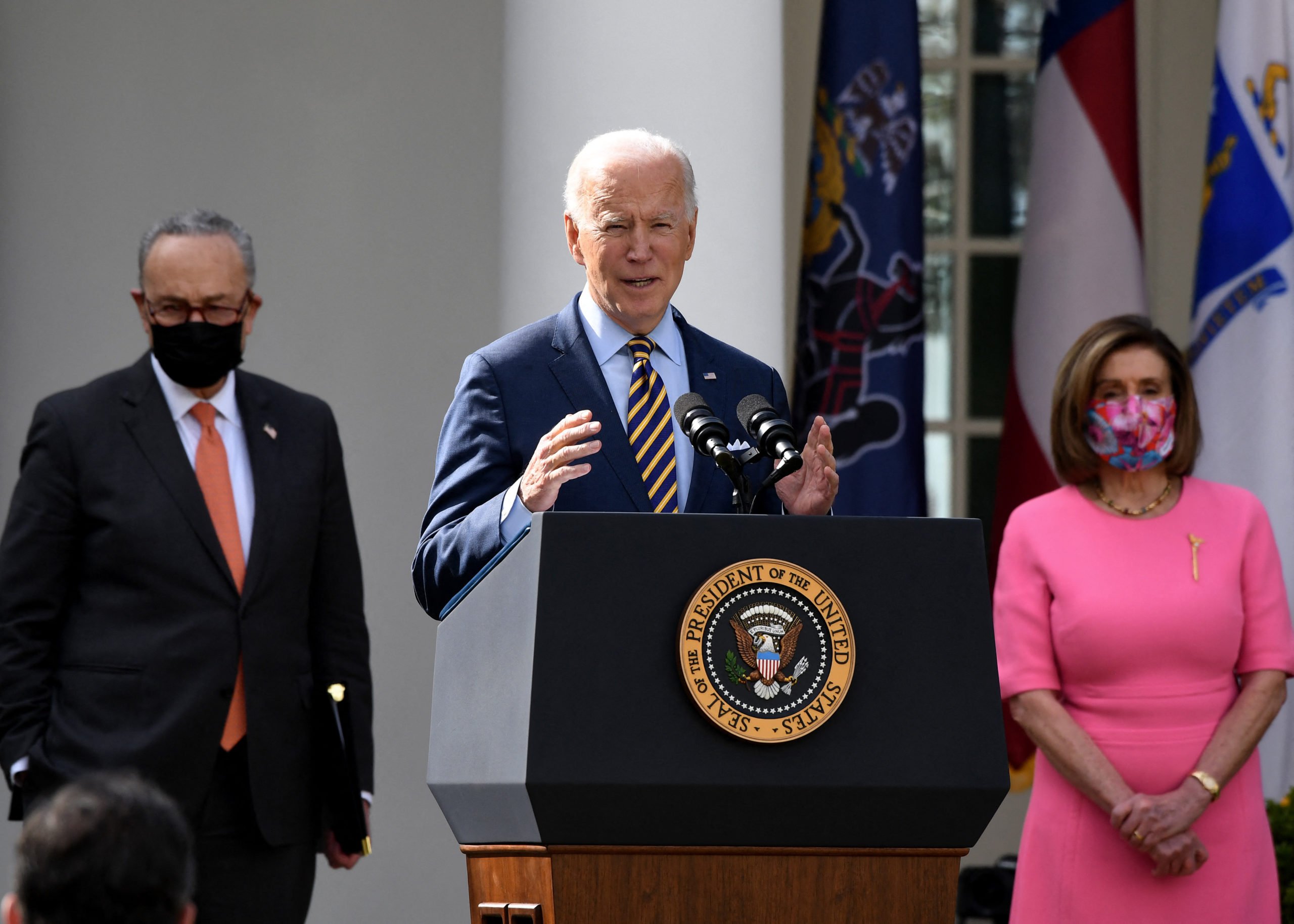 US President Joe Biden, with (L-R) Senate Majority Leader Chuck Schumer, Democrat of New York, and House Speaker Nancy Pelosi, Democrat of California, speaks about the American Rescue Plan in the Rose Garden of the White House in Washington, DC, on March 12, 2021. (Photo by OLIVIER DOULIERY / AFP) (Photo by OLIVIER DOULIERY/AFP via Getty Images)