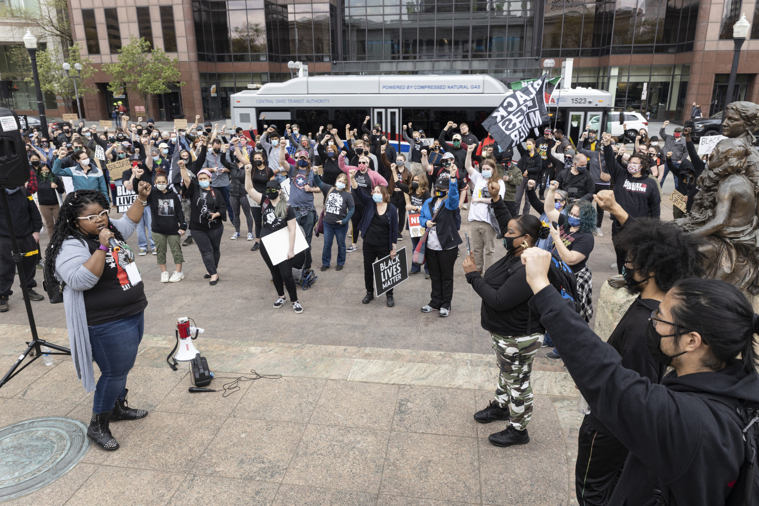 Kiara Yakita raises her fist while leading a protest in front of the Ohio Statehouse on April 17 in Columbus, Ohio. (Stephen Zenner/Getty Images)