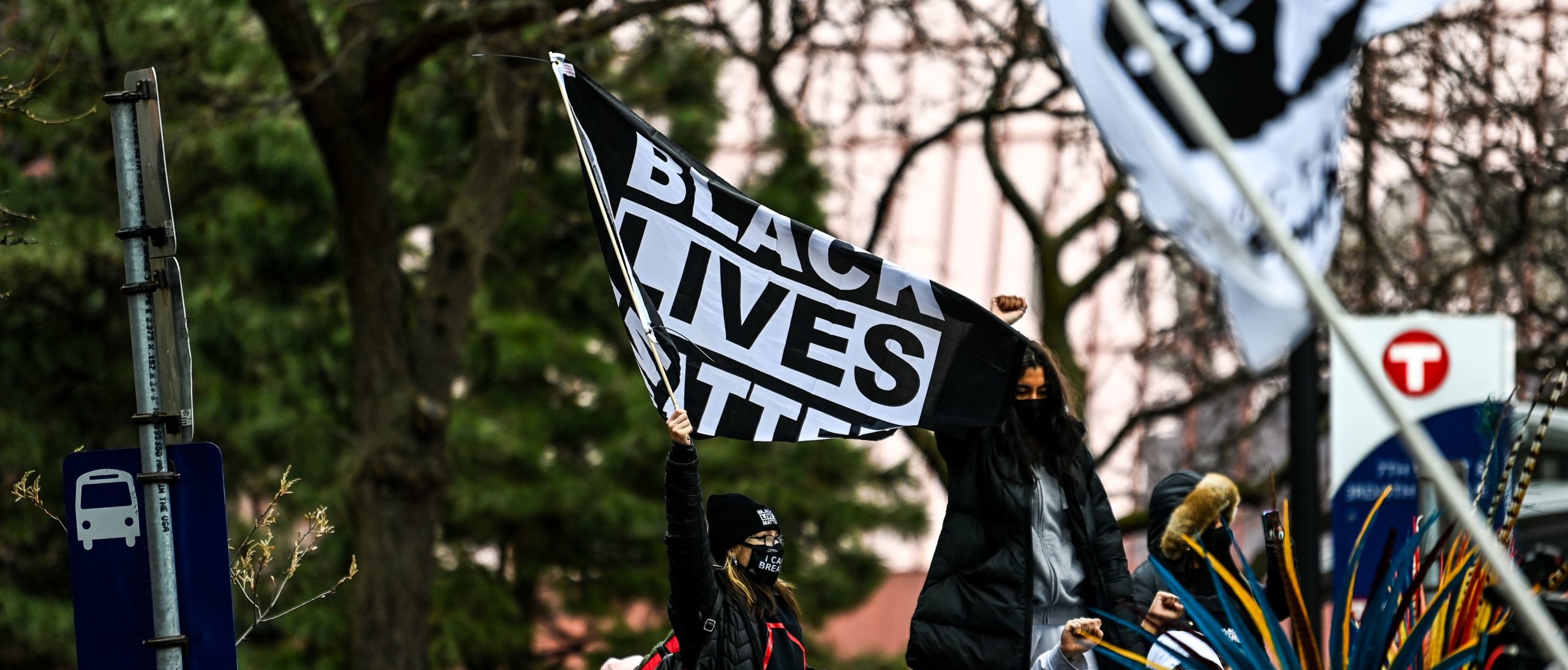 People hold placards as they protest outside of the Courthouse during the trial of former Minneapolis police officer charged with murdering George Floyd in Minneapolis, Minnesota on April 19, 2021. - Jurors on Monday began mulling the fate of the white ex-Minneapolis policeman accused of killing African-American George Floyd, a death that sparked a nationwide reckoning on racism and which prosecutors called a "shocking abuse of authority". (Photo by CHANDAN KHANNA/AFP via Getty Images)