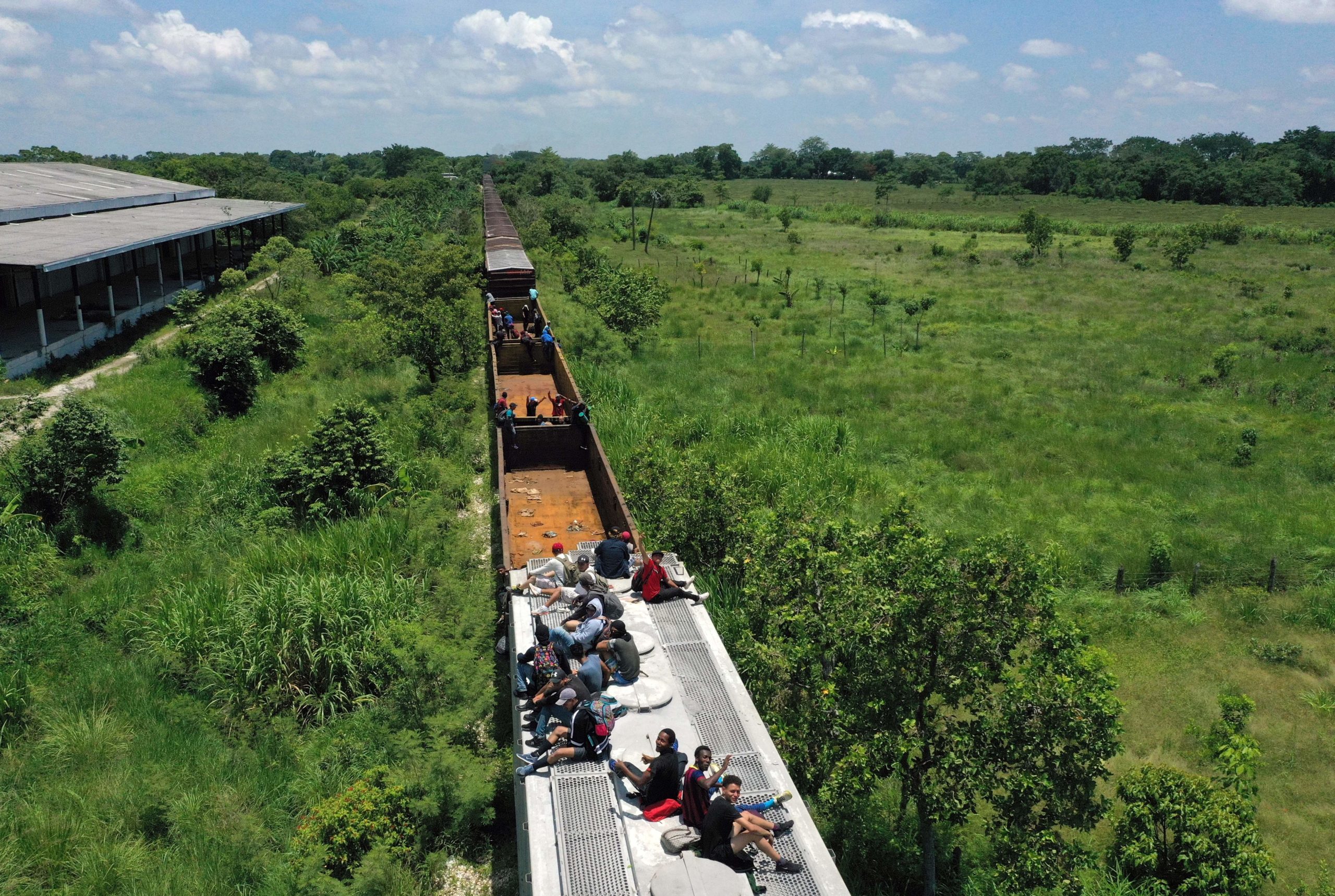 TOPSHOT - Aerial view of migrants on a train known as "The Beast" in Palenque, Chiapas state, Mexico, on July 25, 2019. (Photo credit should read ALFREDO ESTRELLA/AFP via Getty Images)