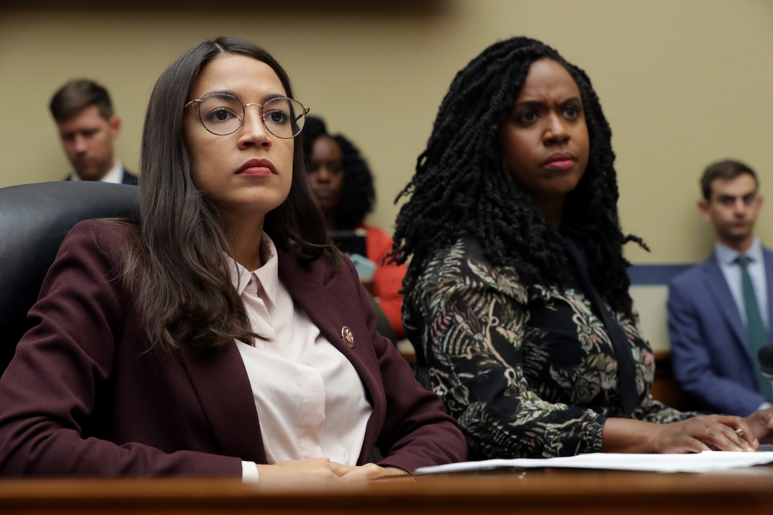 House Oversight and Government Reform Committee members Rep. Alexandria Ocasio-Cortez (D-NY) (L) and Rep. Ayanna Pressley (D-MA) attend a hearing on drug pricing in the Rayburn House Office building on Capitol Hill July 26, 2019 in Washington, DC. As members of a group of four freshman Democratic women of color, known informally as 'The Squad,' the congresswomen heard testimony from patients and their family members about the negative impacts of rising drug prices in the United States. (Photo by Chip Somodevilla/Getty Images)