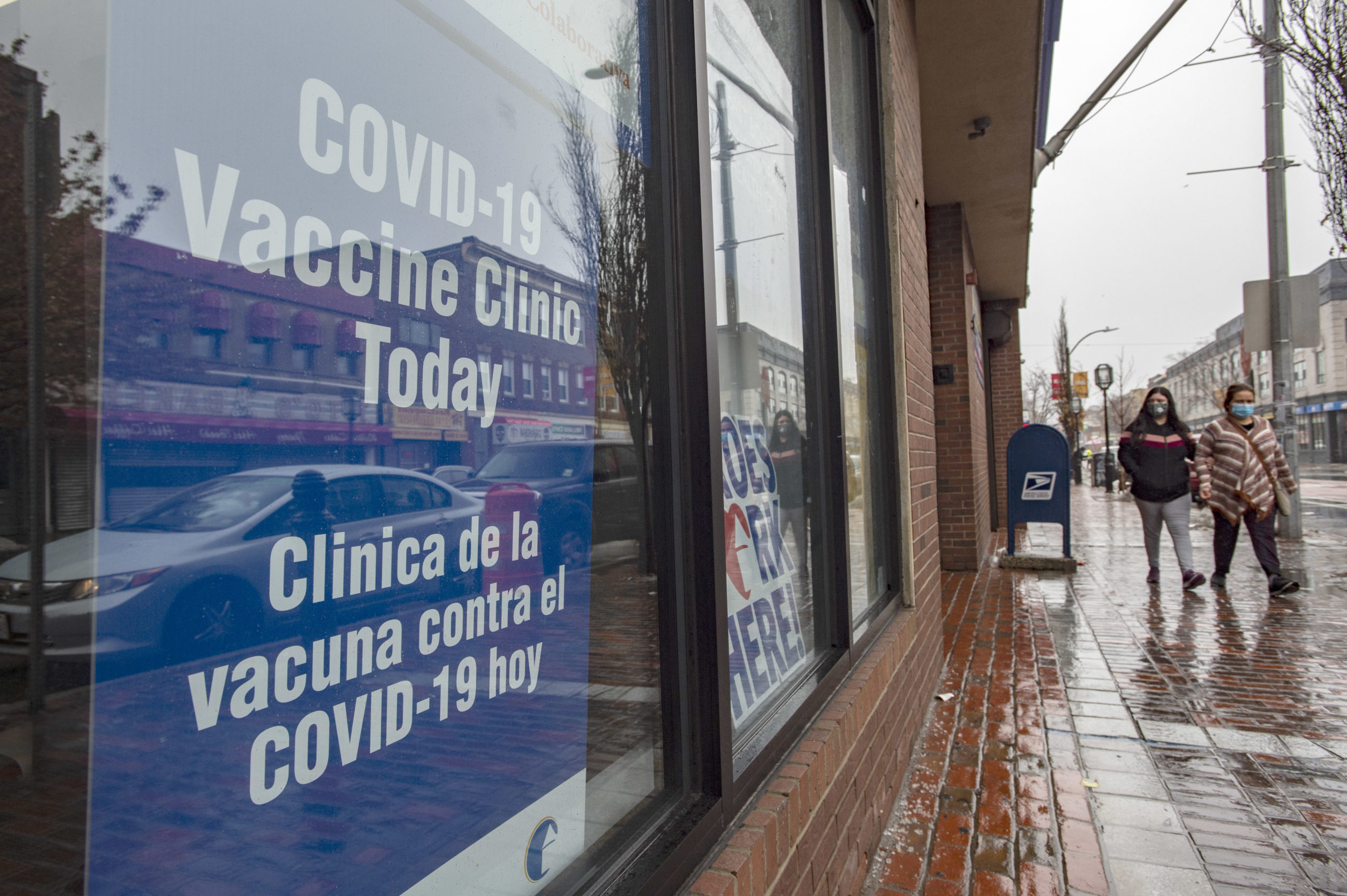Signs in multiple languages let the public know they can get inoculated here at La Colaborativa in Chelsea, Massachusetts on February 16, 2021.  (Photo by JOSEPH PREZIOSO/AFP via Getty Images)