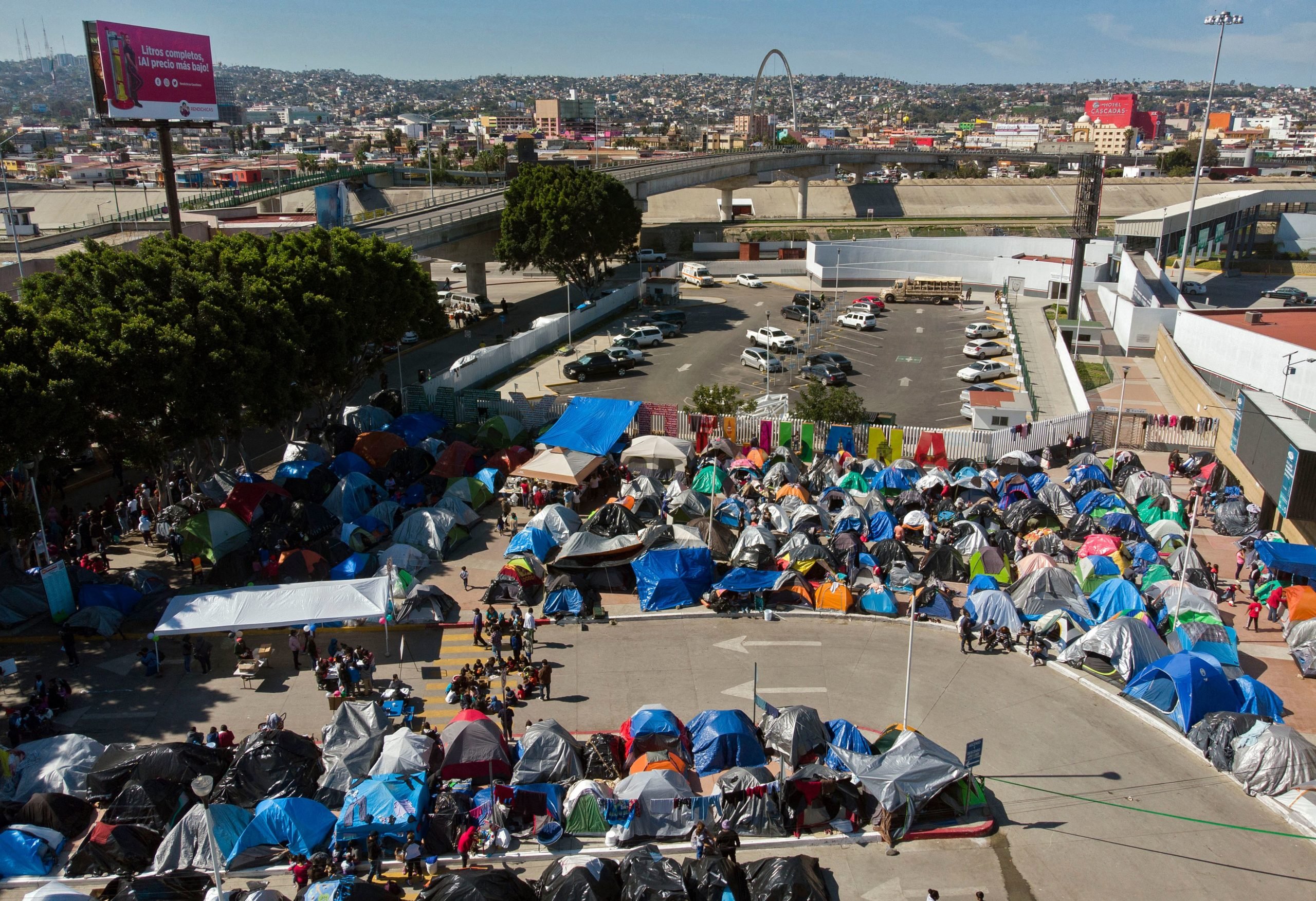 Aerial view of a migrants camp where asylum seekers wait for US authorities to allow them to start their migration process outside El Chaparral crossing port in Tijuana, Baja California state, Mexico on March 17, 2021. (Photo by GUILLERMO ARIAS/AFP via Getty Images)
