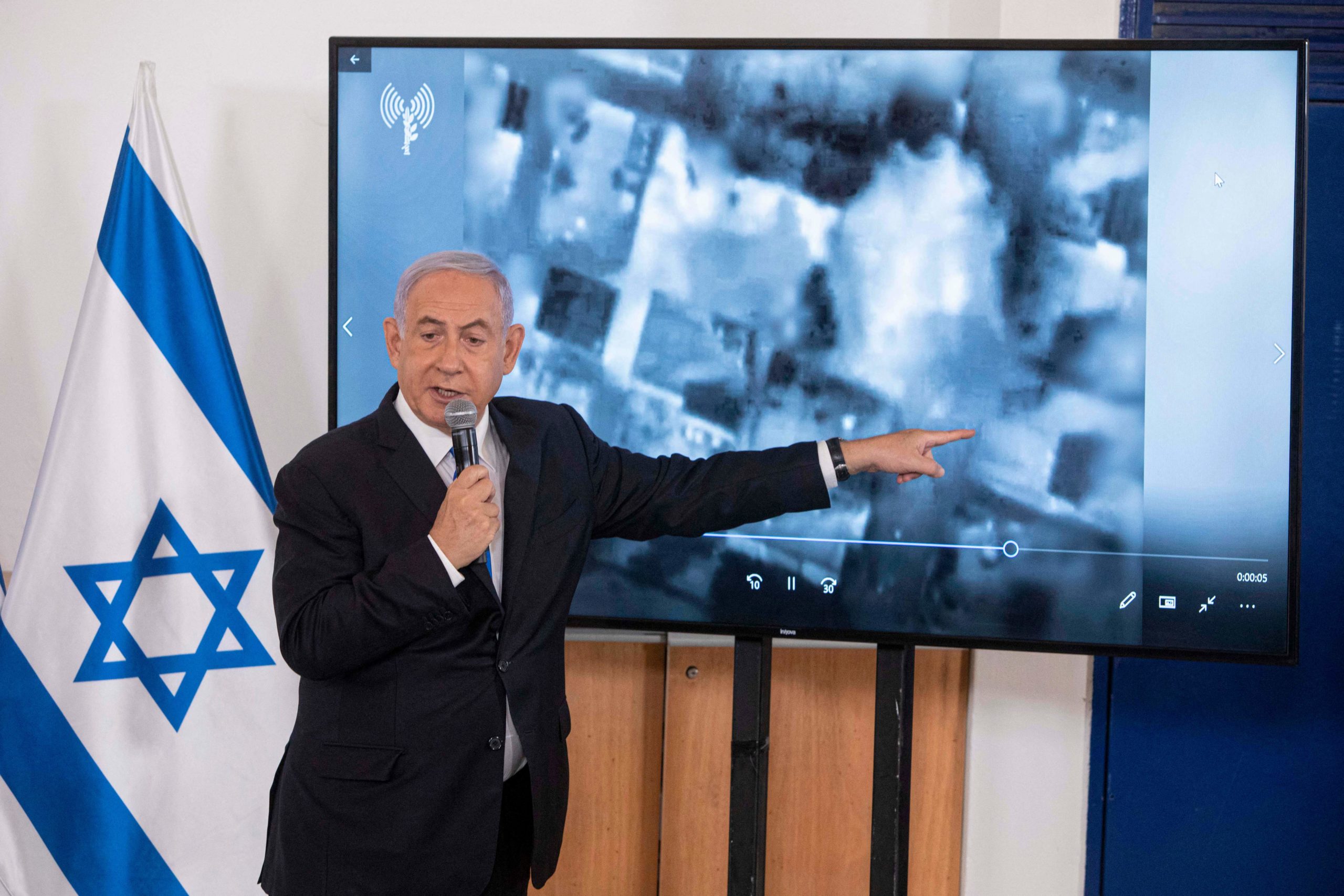 Israeli Prime Minister Benjamin Netanyahu gestures as he shows a slideshow during a briefing to ambassadors to Israel at the Hakirya military base in Tel Aviv, Israel, Wednesday, May 19, 2021. (SEBASTIAN SCHEINER/POOL/AFP via Getty Images)