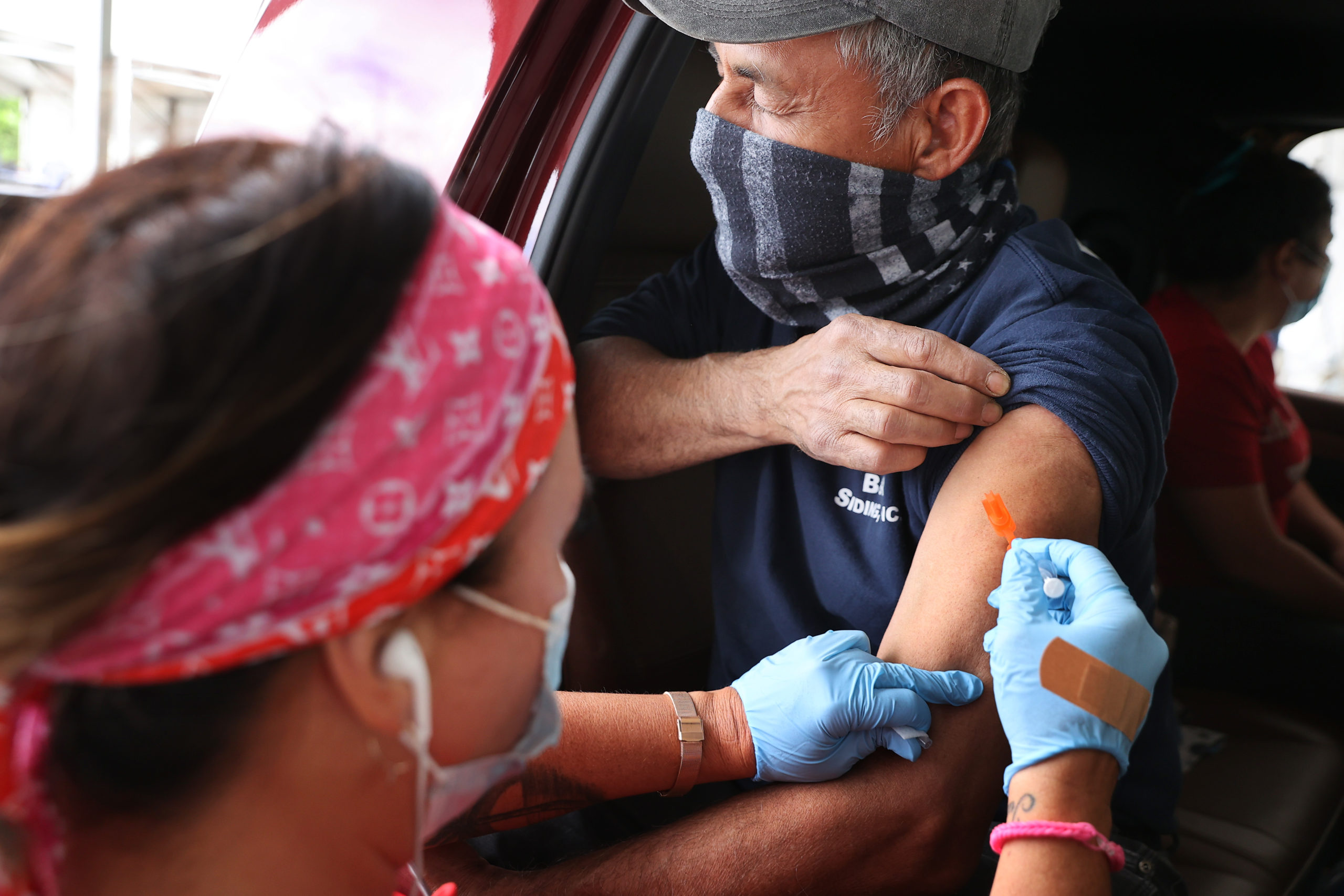 A man receives his first dose of the Pfizer vaccine on Wednesday in Aberdeen, Maryland. (Chip Somodevilla/Getty Images)