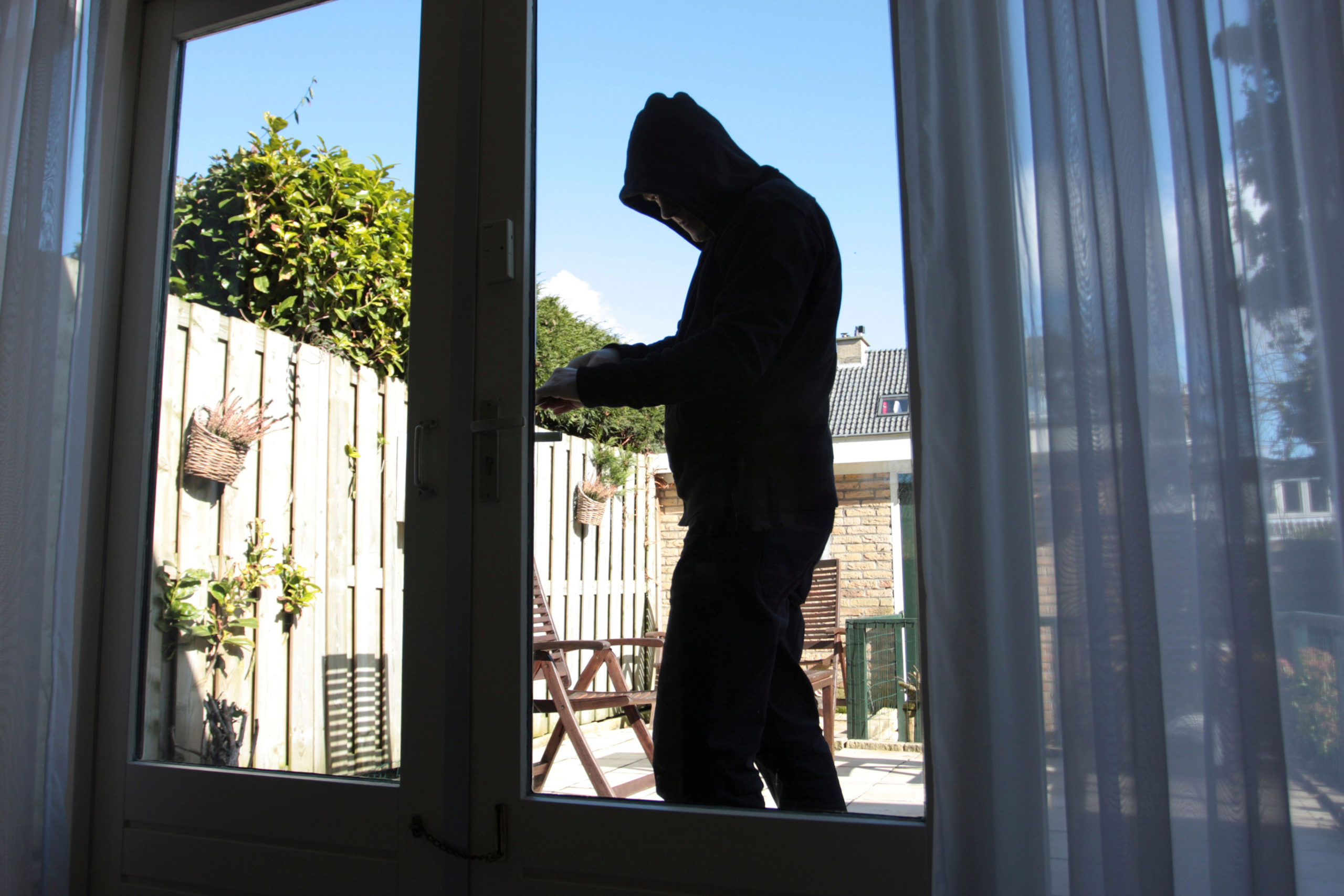 A burglar tries to break into a house. The individual featured here is not the individual mentioned in the story. [Shutterstock]