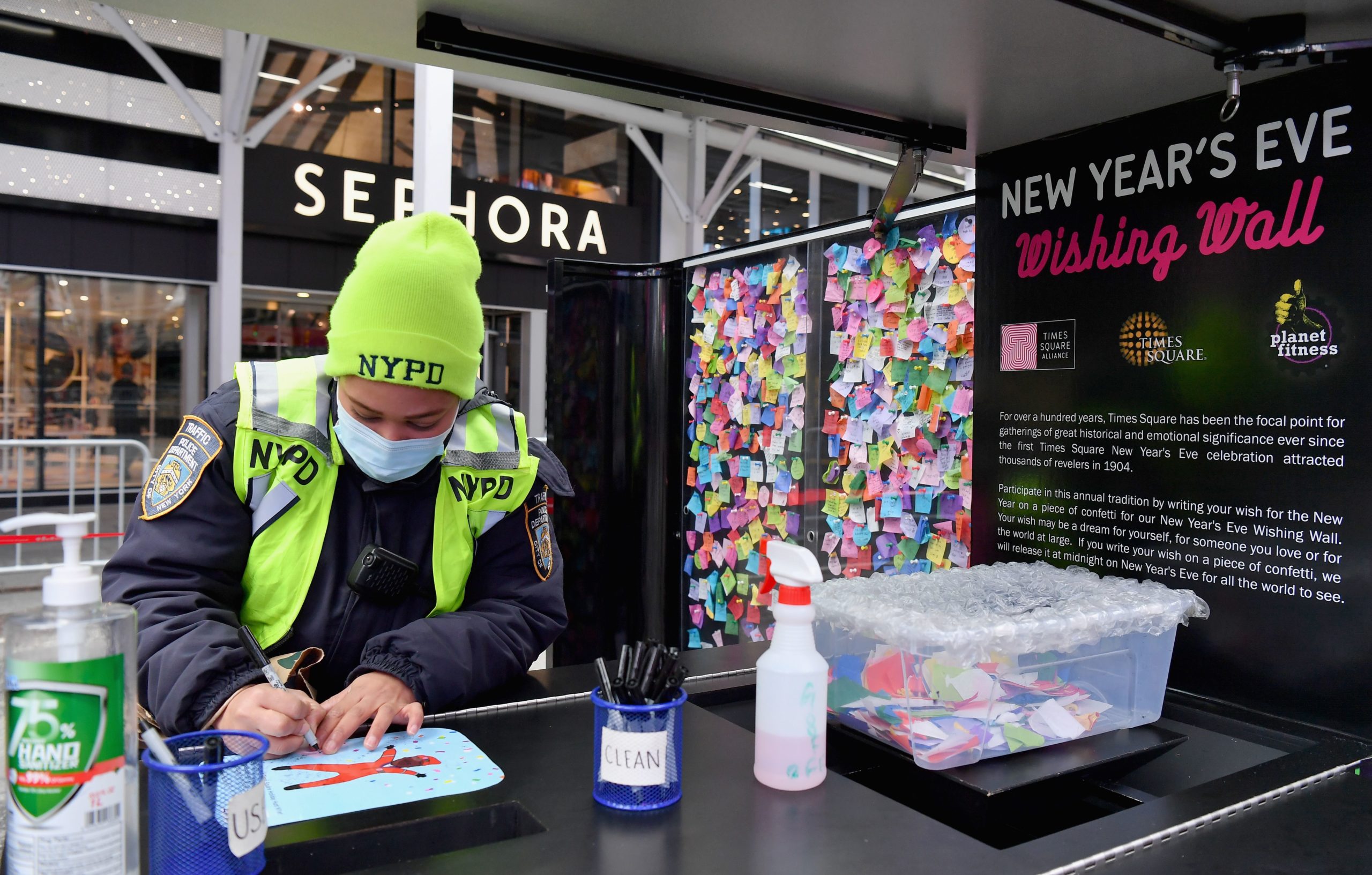 An NYPD officer writes down a note on confetti during the 14th annual Good Riddance Day in Times Square ahead of New year's Eve on December 28, 2020 in New York City. (Photo by ANGELA WEISS/AFP via Getty Images)