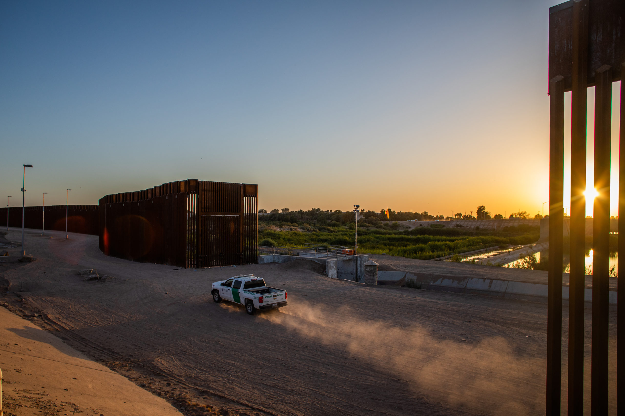 YUMA, AZ - MAY 12: A border patrol truck drives by the wall at the US-Mexico border on May 12, 2021 in Yuma, Arizona. The Biden administration is trying to develop a plan to safely handle the surge of immigrants coming across the Southern border. (Photo by Apu Gomes/Getty Images)