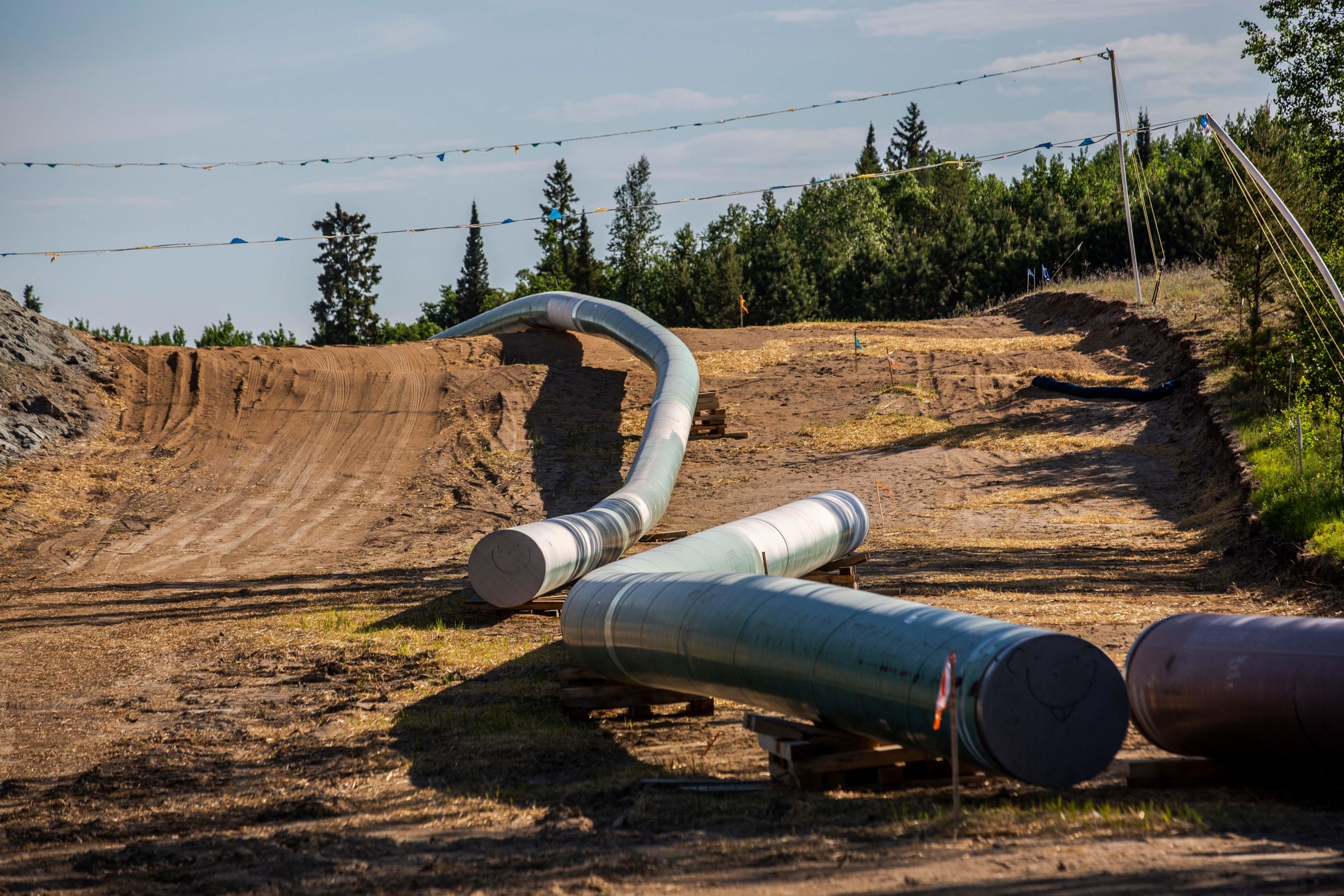 Sections of the Enbridge Line 3 pipeline are seen on the construction site on the White Earth Nation Reservation near Wauburn, Minnesota, on June 5, 2021. - Indigenous leaders and climate activists are gathering in northern Minnesota to protest the construction of the Line 3 oil pipeline. Line 3 is an oil sands pipeline which runs from Hardisty, Alberta, Canada to Superior, Wisconsin in the United States. In 2014, a new route for the Line 3 pipeline was proposed to allow an increased volume of oil to be transported daily. While that project has been approved in Canada, Wisconsin, and North Dakota, it has sparked continued resistance from climate justice groups and Native American communities in Minnesota. While many people are concerned about potential oil spills along Line 3, some Native American communities in Minnesota have opposed the project on the basis of treaty rights. (Photo by Kerem YUCEL / AFP) (Photo by KEREM YUCEL/AFP via Getty Images)