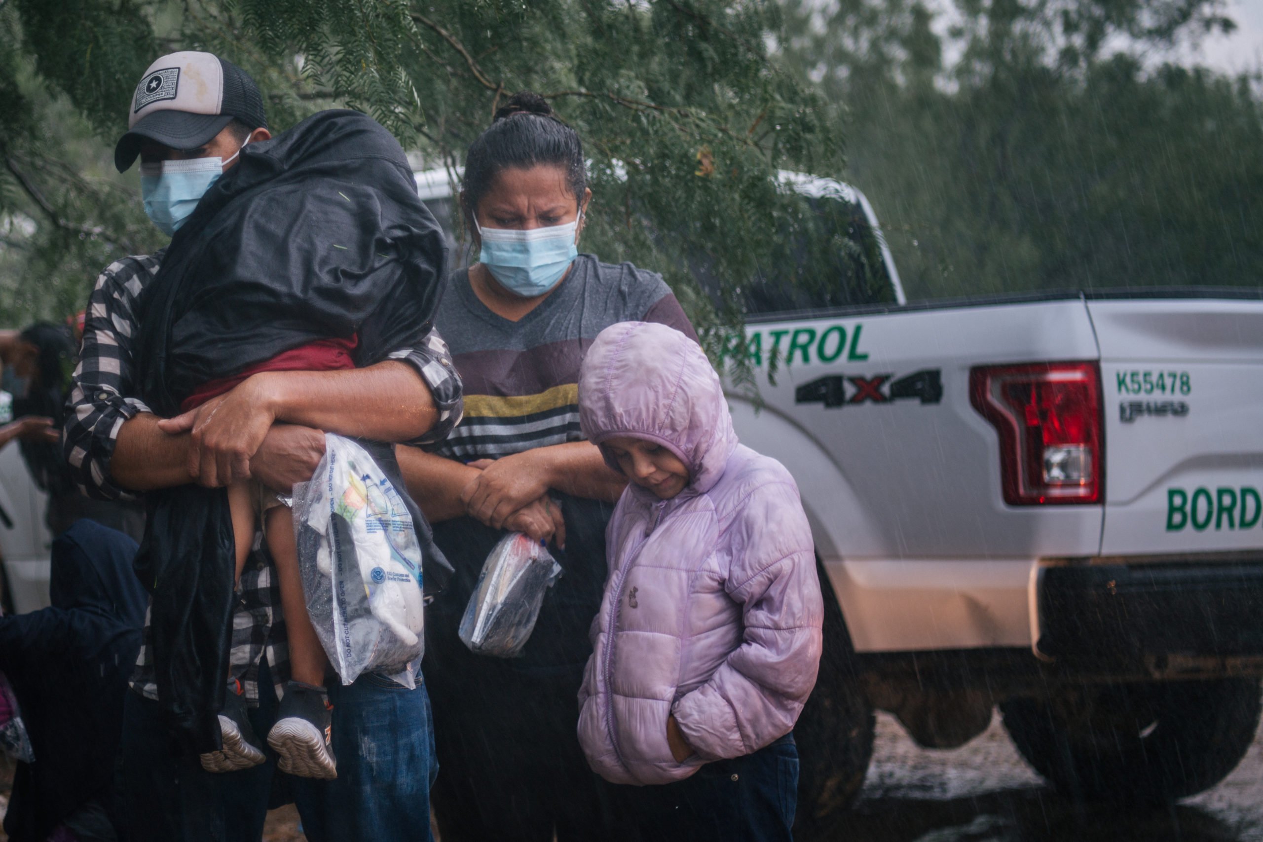An immigrants family seeking asylum prepares to be taken to a border patrol processing facility after crossing into the U.S. on June 16, 2021 in LaJoya, Texas. (Photo by Brandon Bell/Getty Images)