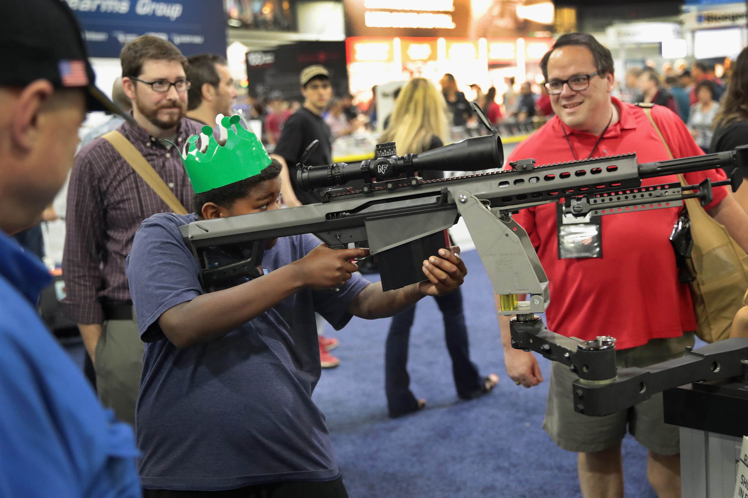 National Rifle Association members look over guns in the Barrett display at the 146th NRA Annual Meetings Exhibits on April 29, 2017 in Atlanta, Georgia. (Photo by Scott Olson/Getty Images)