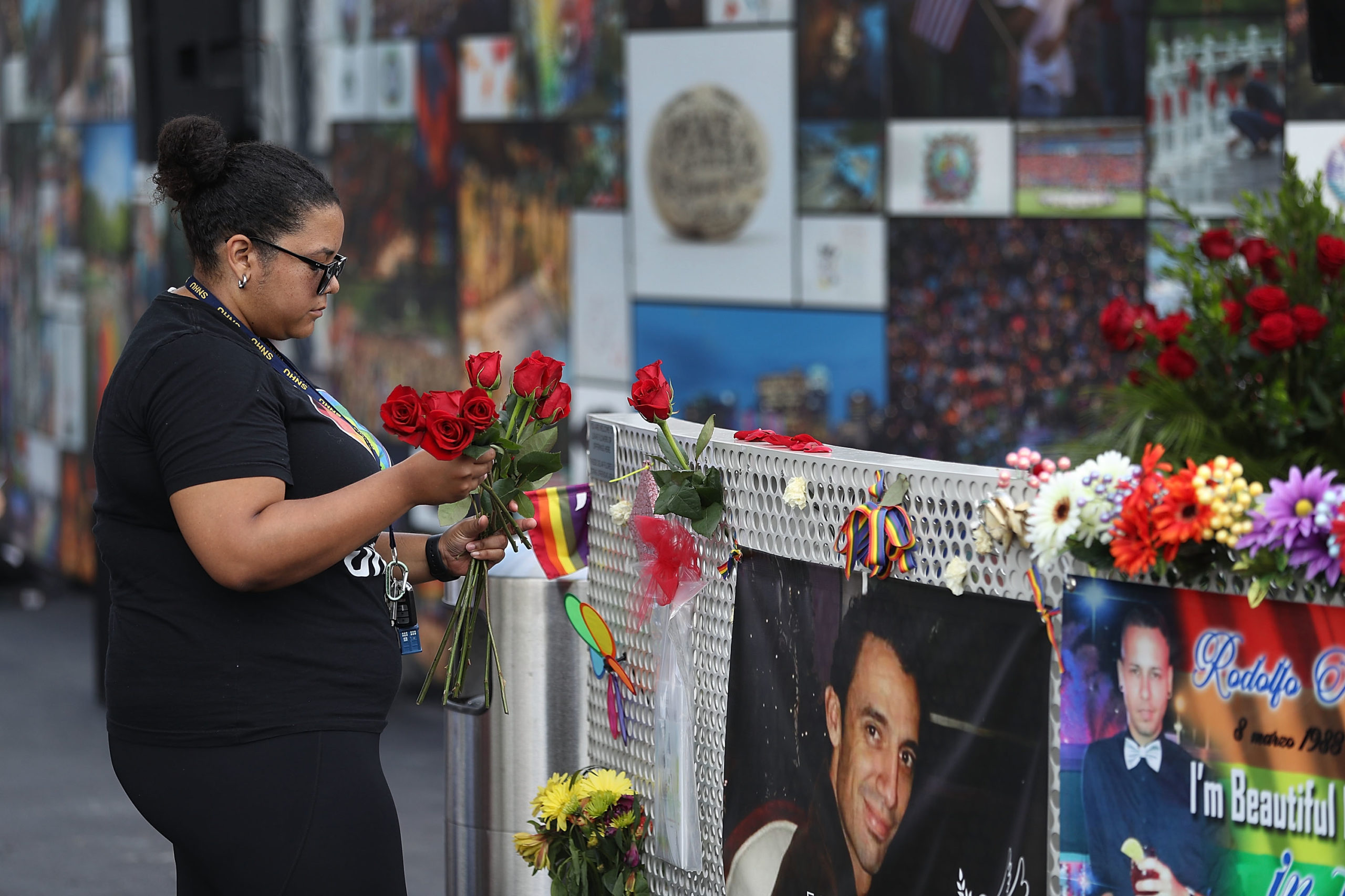 ORLANDO, FL - JUNE 12: Bianca Booker places flowers on a fence at the memorial set up for the shooting victims at Pulse nightclub where the shootings took place two years ago on June 12, 2018 in Orlando, Florida. On June 12, 2016 a mass shooting took place at Pulse nightclub killing 49 people and wounding 53 in one of the worst mass shootings in U.S. history. (Photo by Joe Raedle/Getty Images)