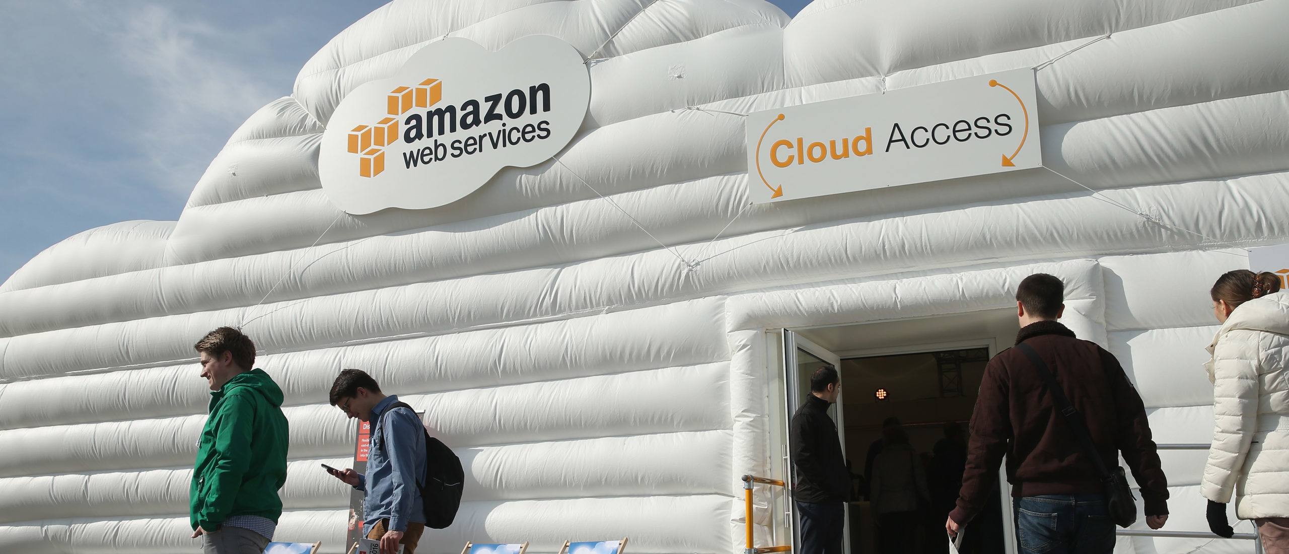 Visitors arrive at the cloud pavillion of Amazon Web Services at the 2016 CeBIT digital technology trade fair. (Photo by Sean Gallup/Getty Images)