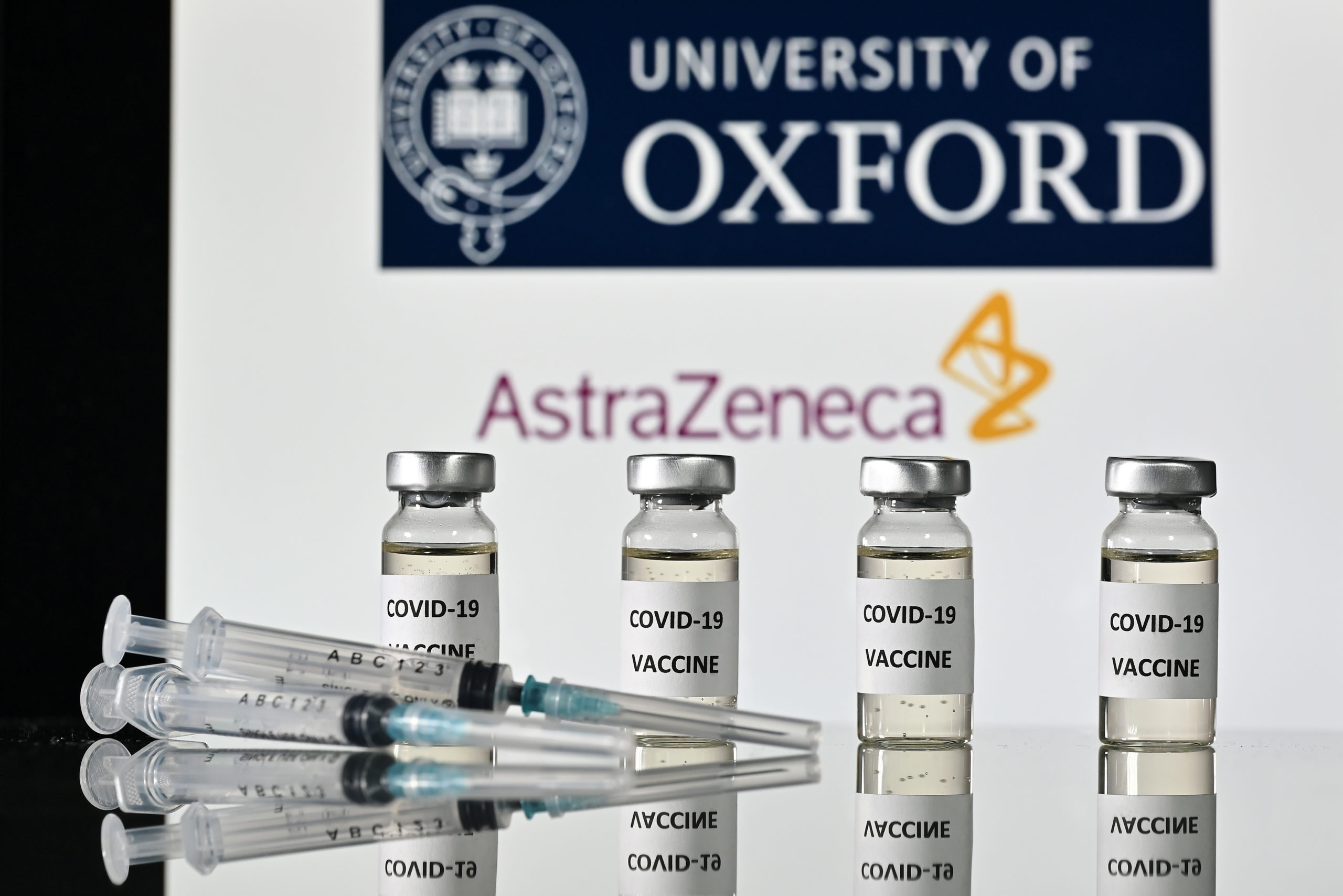 An illustration picture shows vials with Covid-19 Vaccine stickers attached and syringes, with the logo of the University of Oxford and its partner British pharmaceutical company AstraZeneca, on November 17, 2020. (Photo by JUSTIN TALLIS/AFP via Getty Images)