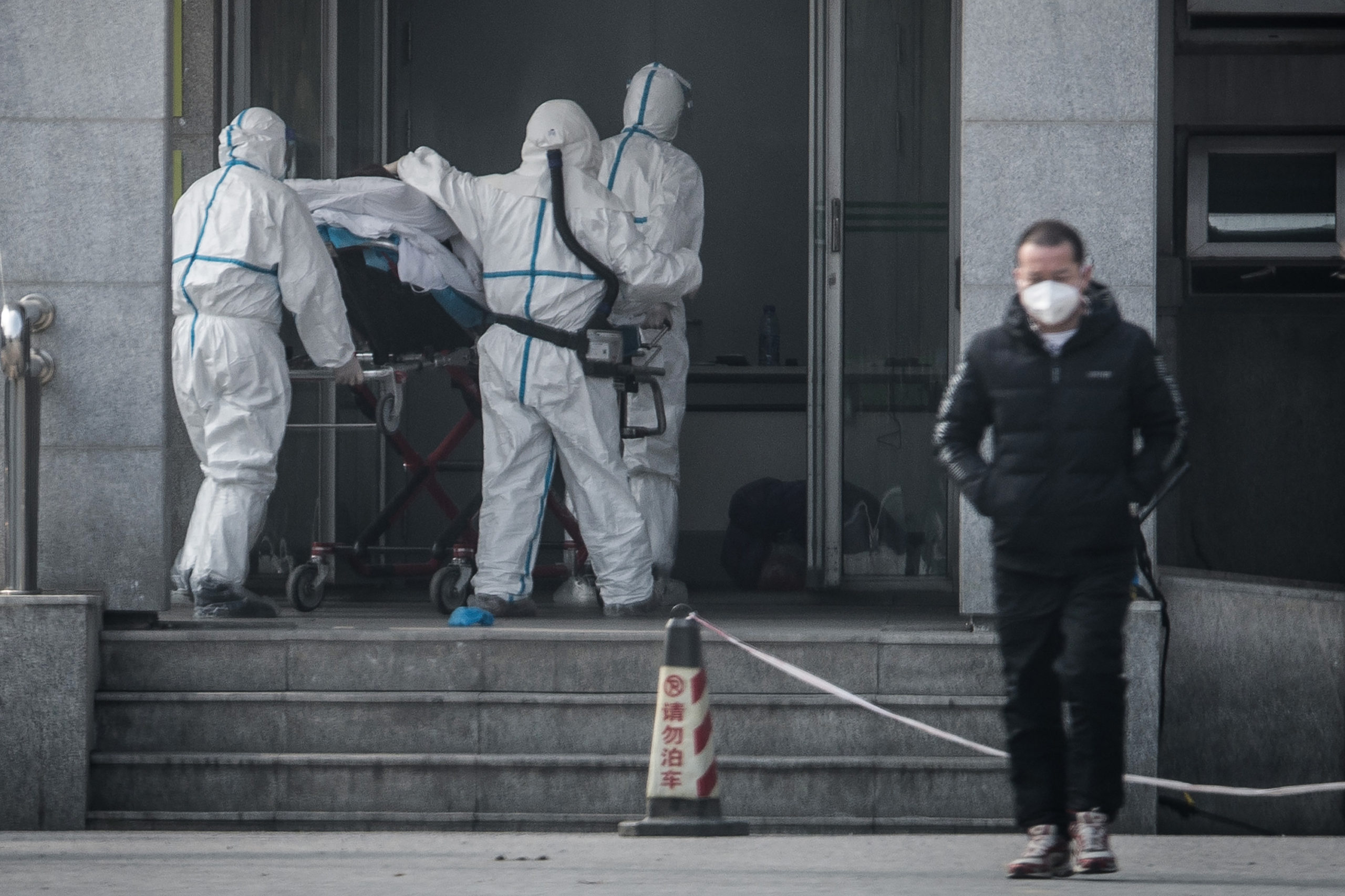 Medical staff members carry a patient into a Chinese hospital where patients infected by a "mysterious SARS-like virus" were treated in Wuhan, China on Jan. 18, 2020. (STR/AFP via Getty Images)