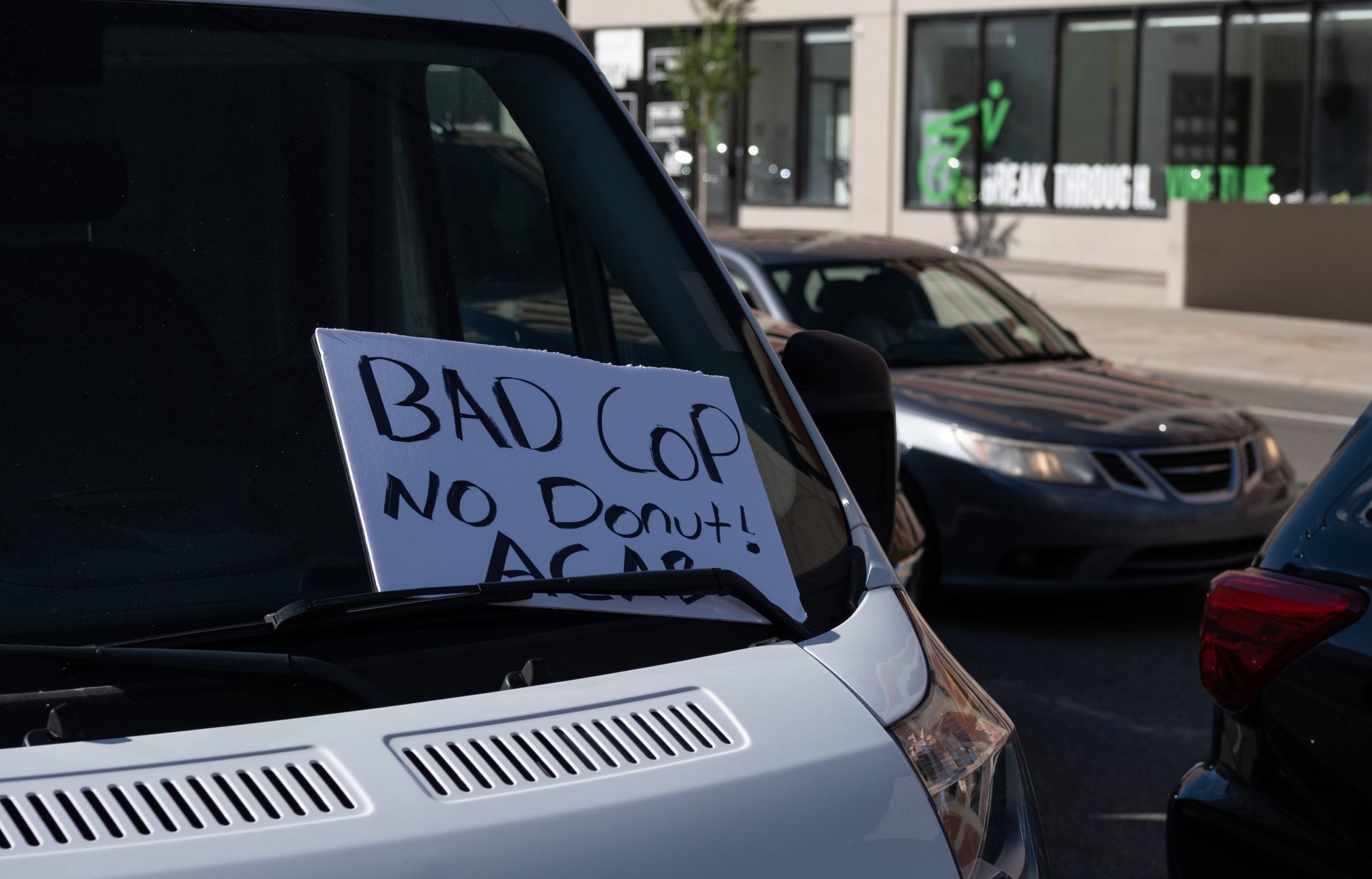 A sign on a van window reads "Bad cop no donut! ACAB" as protesters march in Detroit, Michigan on May 31, 2020 following a night of protests that saw several arrests and uses of tear gas by the Detroit Police department on what was peaceful protesting. - Thousands of National Guard troops patrolled major US cities after five consecutive nights of protests over racism and police brutality that boiled over into arson and looting, sending shock waves through the country. The death Monday of an unarmed black man, George Floyd, at the hands of police in Minneapolis ignited this latest wave of outrage in the US over law enforcement's repeated use of lethal force against African Americans -- this one like others before captured on cellphone video. (Photo by SETH HERALD / AFP) (Photo by SETH HERALD/AFP via Getty Images)