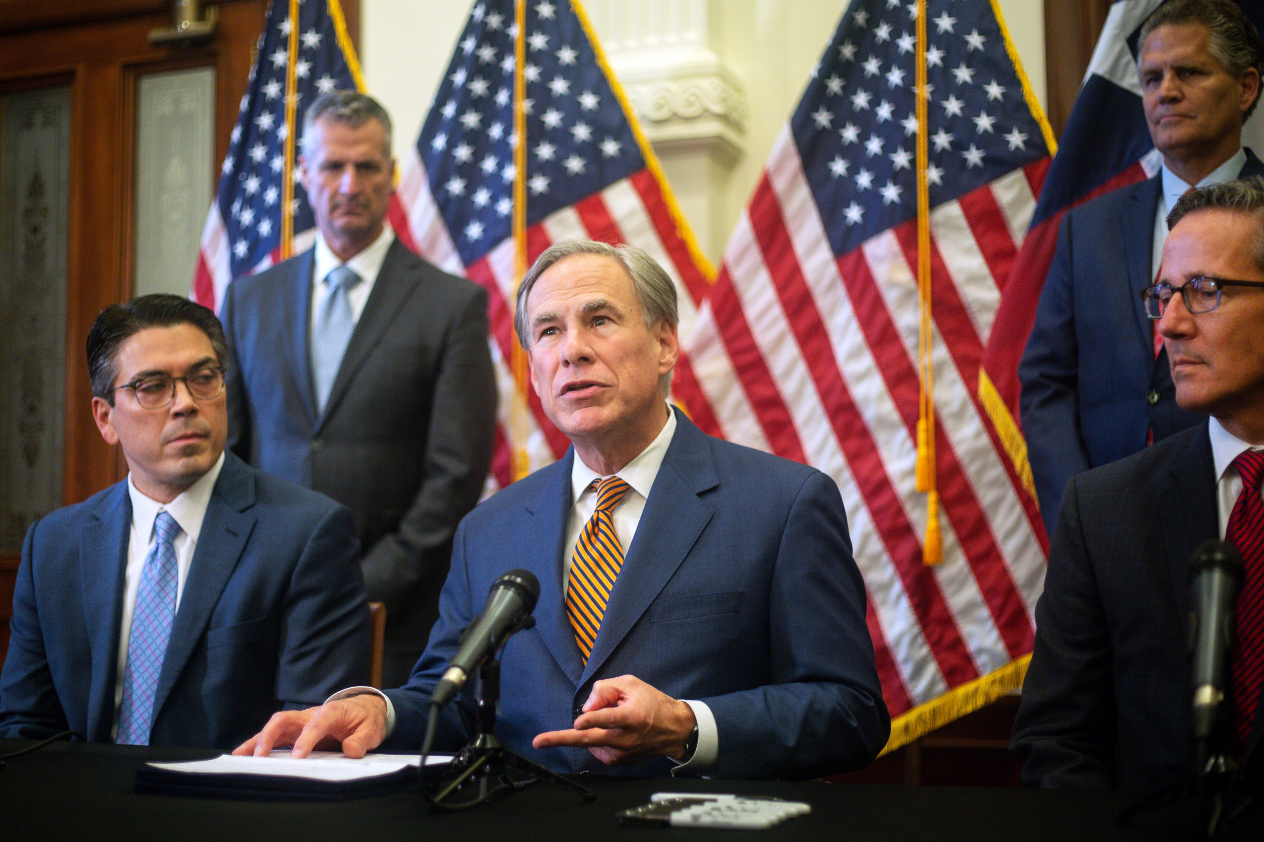 AUSTIN, TX - JUNE 08: (L-R) State Rep. Chris Paddie, Texas Governor Greg Abbott and State Senator Kelly Hancock attend a press conference where Abbott signed Senate Bills 2 and 3 at the Capitol on June 8, 2021 in Austin, Texas. Governor Abbott signed the bills into law to reform the Electric Reliability Council of Texas and weatherize and improve the reliability of the state's power grid. The bill signing comes months after a disastrous February winter storm that caused widespread power outages and left dozens of Texans dead. (Photo by Montinique Monroe/Getty Images)