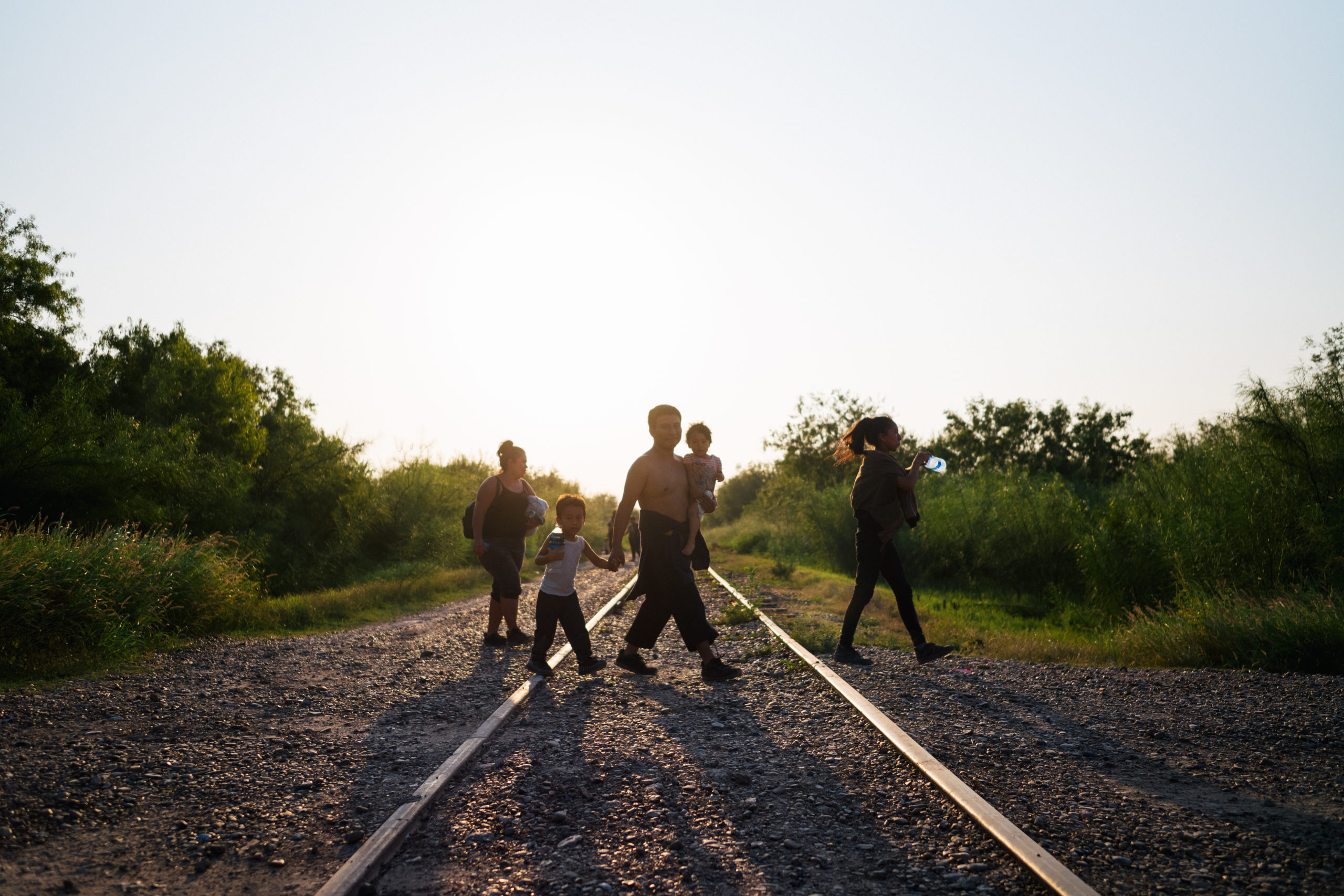 LA JOYA, TEXAS - JUNE 21: Immigrants walk towards border patrol after crossing the Rio Grande into the U.S. on June 21, 2021 in La Joya, Texas. A surge of mostly Central American immigrants crossing into the United States has challenged U.S. immigration agencies along the U.S. Southern border. (Photo by Brandon Bell/Getty Images)