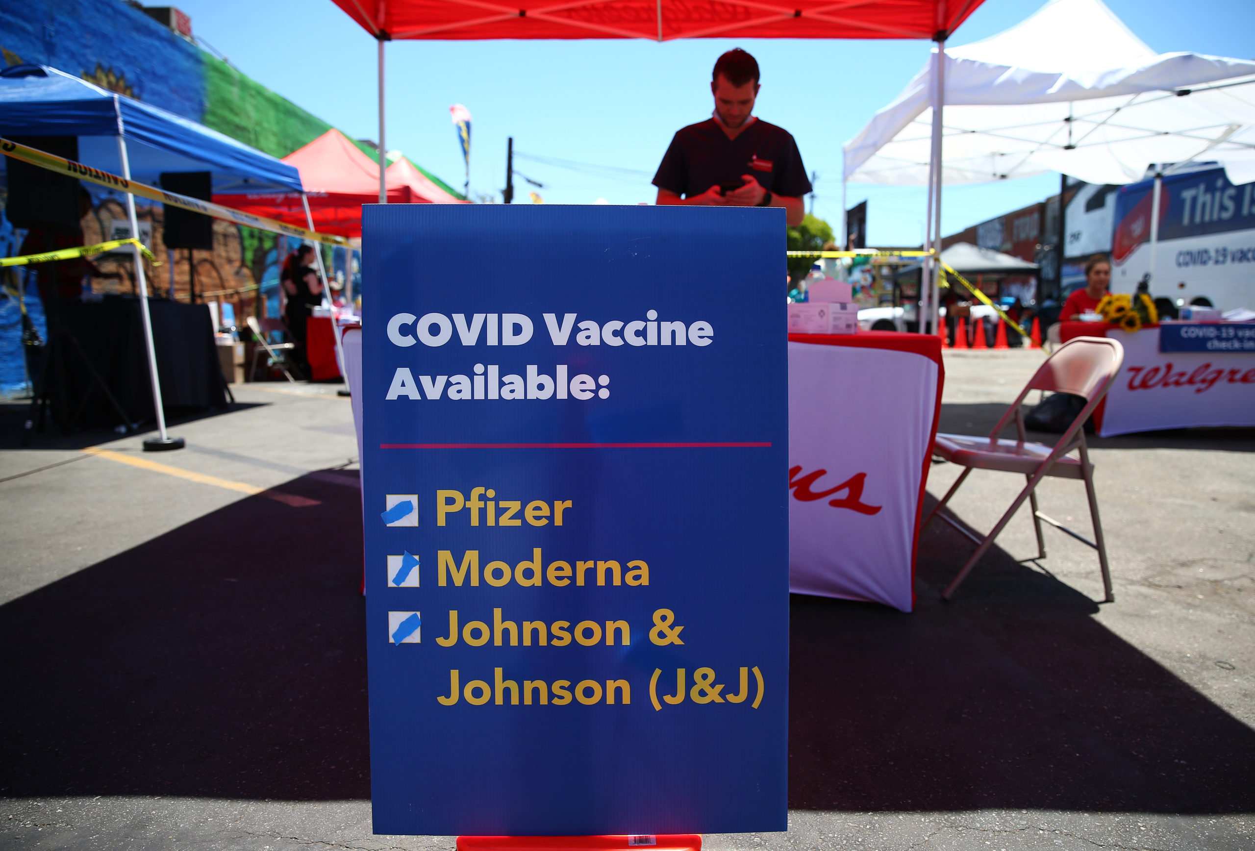 A sign displays the types of coronavirus vaccination doses available at a mobile clinic on June 25 in Los Angeles, California. (Mario Tama/Getty Images)