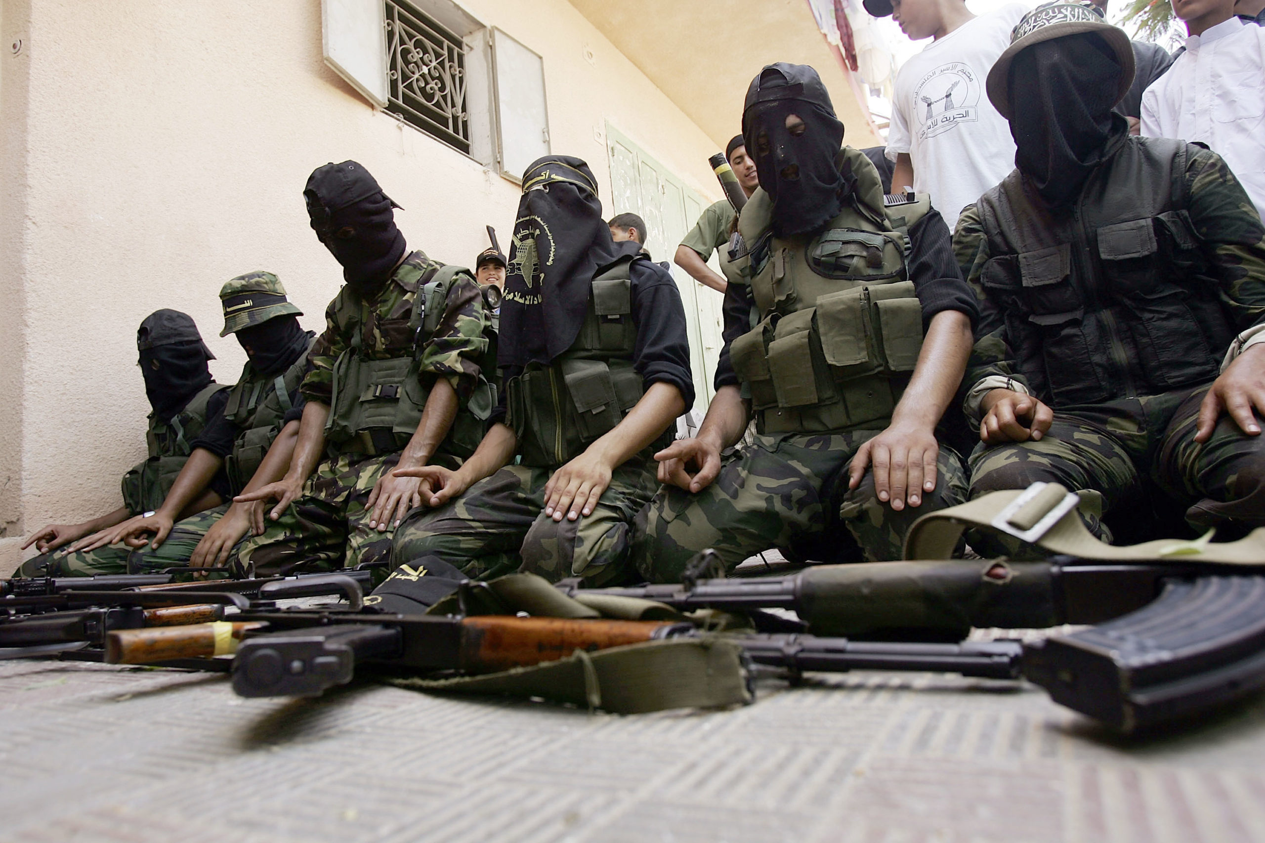 GAZA CITY, GAZA STRIP - AUGUST 12: Members of the controversial Palestinian group Islamic Jihad display weapons while praying before walking through the streets in a march with supporters August 12, 2005 Gaza City, the Gaza Strip. As Israel prepares for a pullout of settlements in both Gaza and the West Bank, various Palestinian groups are vying for power in the post settlement Gaza. (Photo by Spencer Platt/Getty Images)