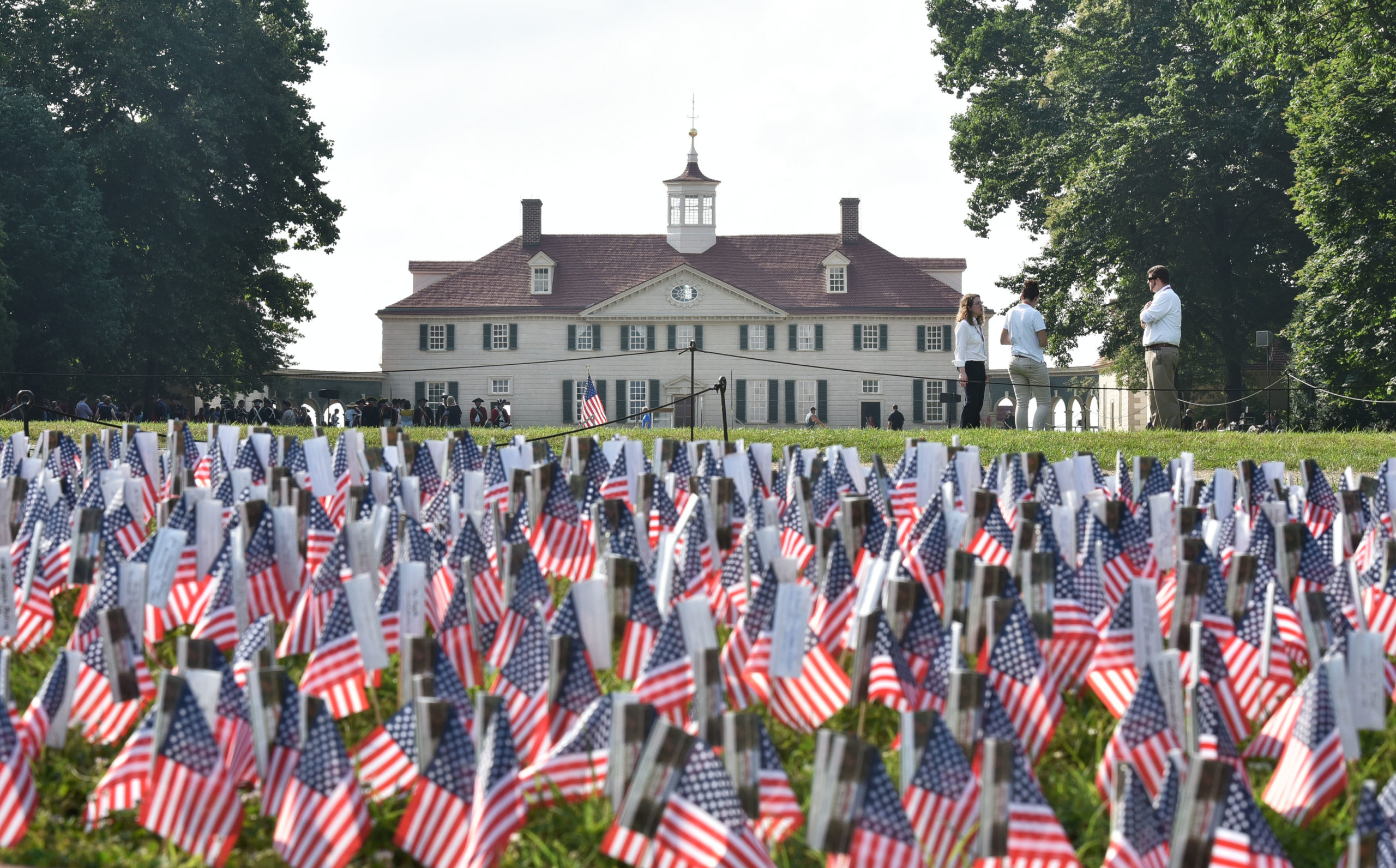 A field of US flags are seen in front of George Washington's Mount Vernon estate during Independence Day celebrations in Mount Vernon, Virginia, on July 4. (Photo by MANDEL NGAN/AFP via Getty Images)
