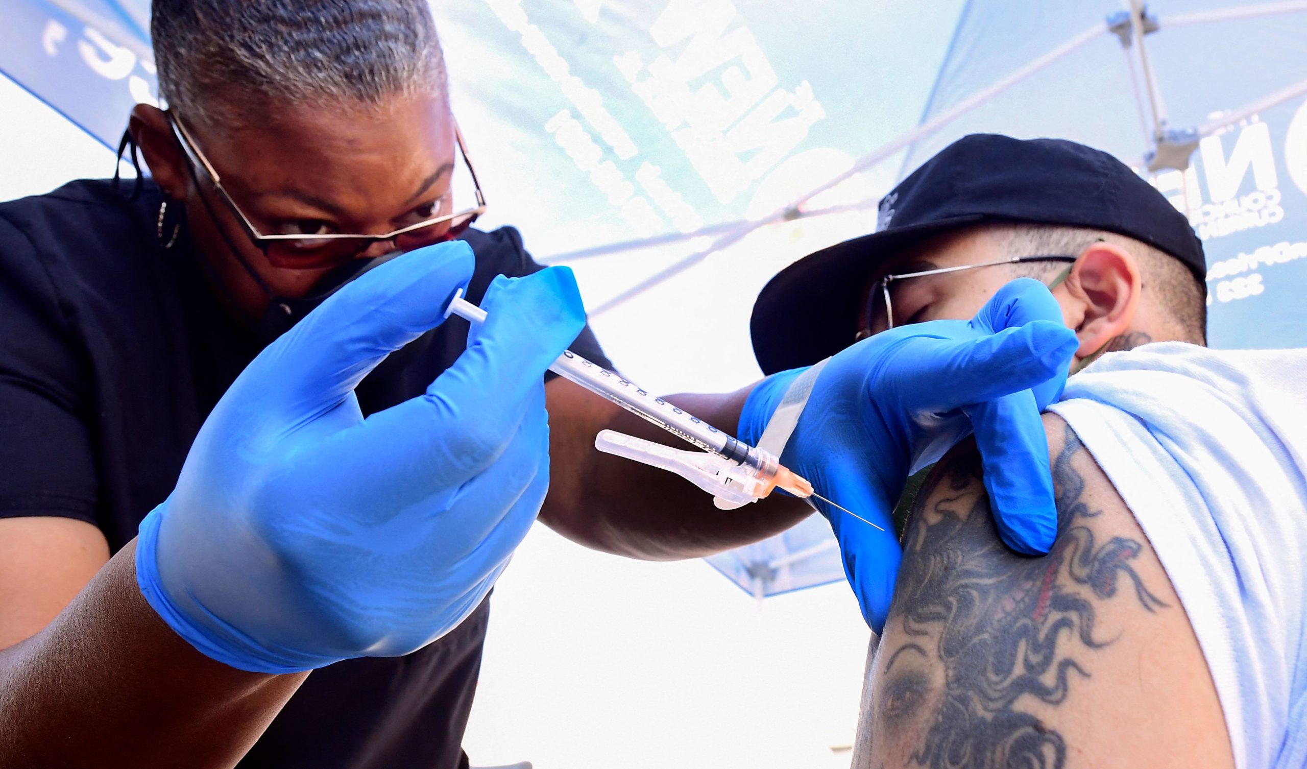 Nurse Eon Walk administers the Pfizer Covid-19 vaccine at a mobile vaccine clinic hosted by Mothers in Action and operated by the Los Angeles County of Public Health on July 16, 2021 in Los Angeles, California. (Photo by FREDERIC J. BROWN/AFP via Getty Images)