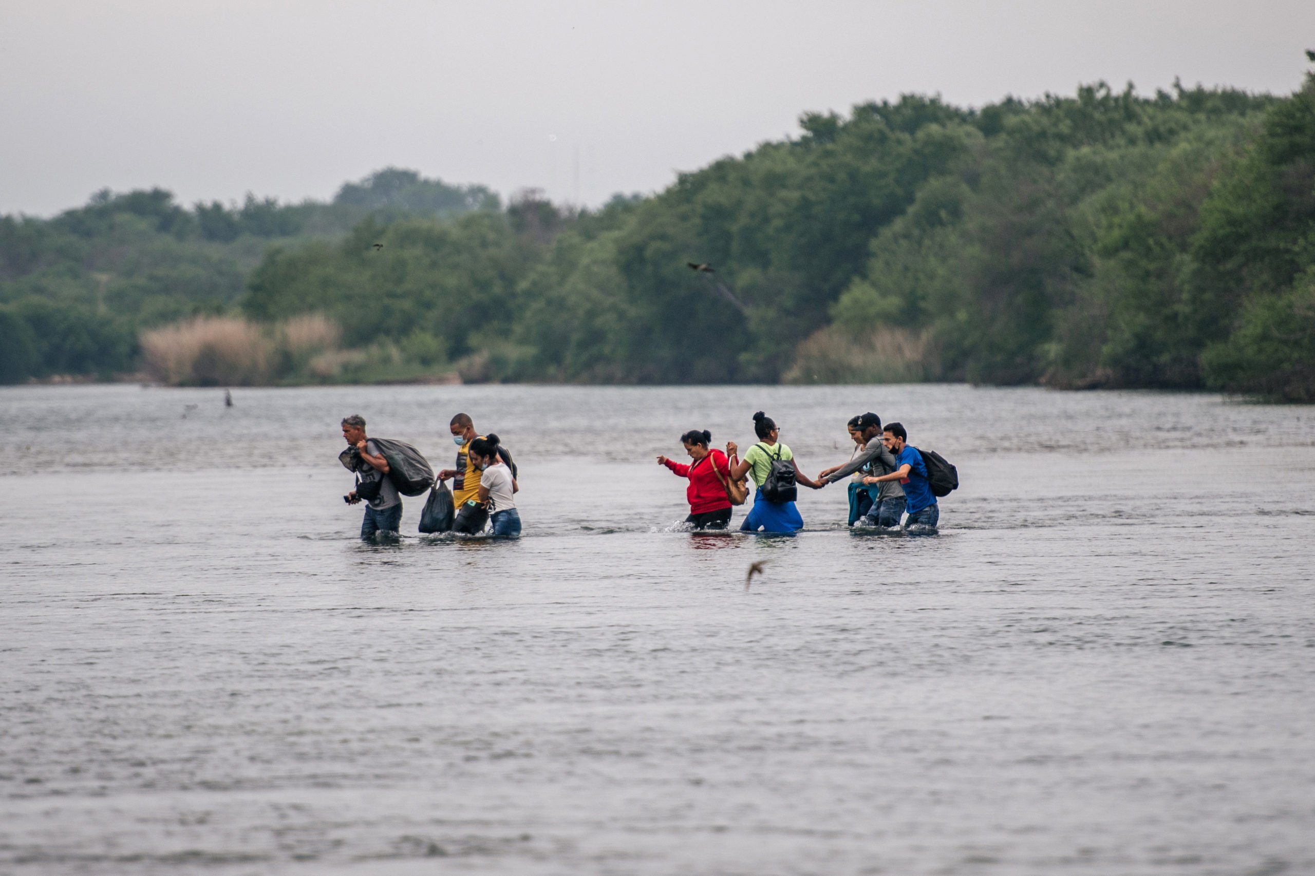 DEL RIO, TEXAS - MAY 17: Immigrants cross the Rio Grande river into the U.S. on May 17, 2021 in Del Rio, Texas. A surge of mostly Central American immigrants crossing into the United States has challenged U.S. immigration agencies along the U.S. Southern border. (Photo by Brandon Bell/Getty Images)