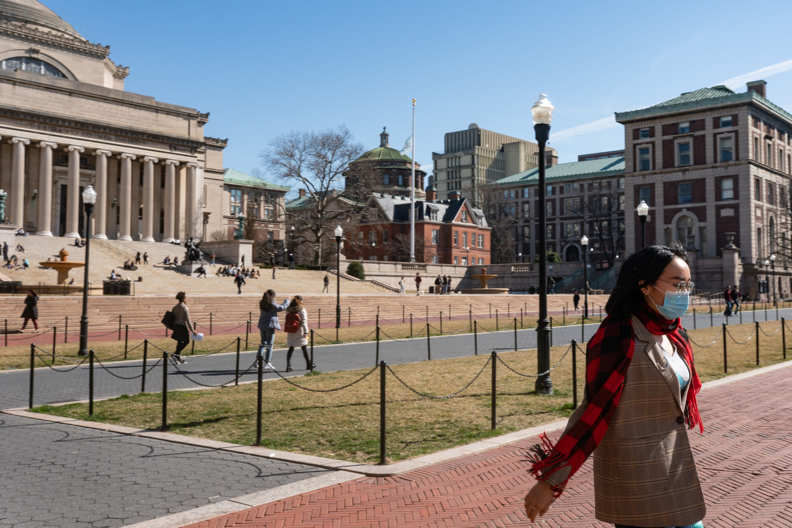 Students congregate in the campus of Columbia University. (Photo by Jeenah Moon/Getty Images)