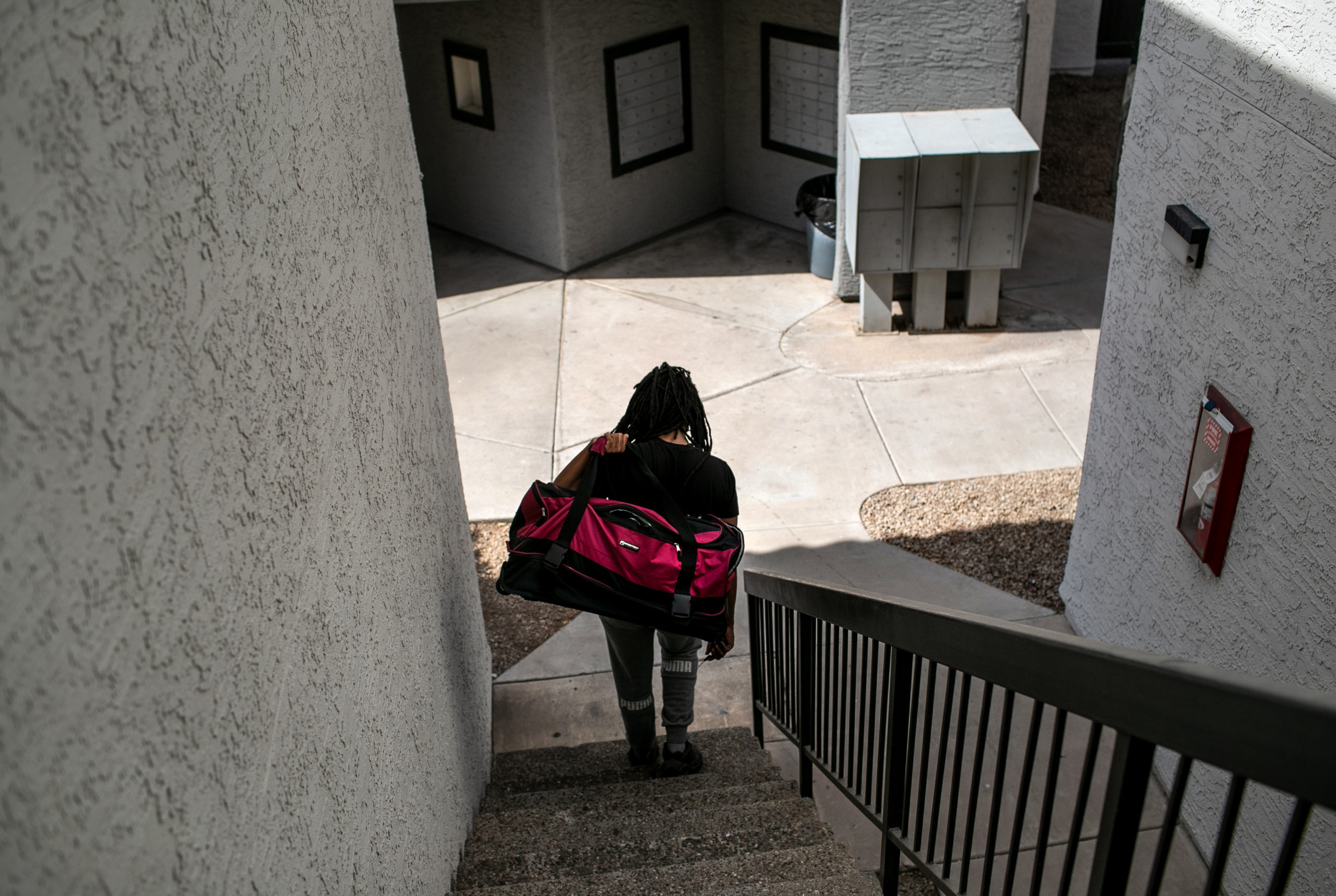 PHOENIX, ARIZONA - OCTOBER 05: An apartment resident carries out a bag of clothing while being evicted for non-payment of rent on October 5, 2020 in Phoenix, Arizona. Thousands of court-ordered evictions continue nationwide despite a Centers for Disease Control (CDC) moratorium for renters impacted by the coronavirus pandemic. Although state and county officials say they have tried to educate the public on the protections, many renters remain unaware and fail to complete the necessary forms to remain in their homes. In many cases landlords have worked out more flexible payment plans with vulnerable tenants, although these temporary solutions have become fraught as the pandemic drags on. With millions of Americans still unemployed due to the pandemic, federal rental assistance proposals remain gridlocked in Congress. The expiry of the CDC moratorium at year's end looms large, as renters and landlord face a potential tsunami of evictions and foreclosures nationwide. (Photo by John Moore/Getty Images)