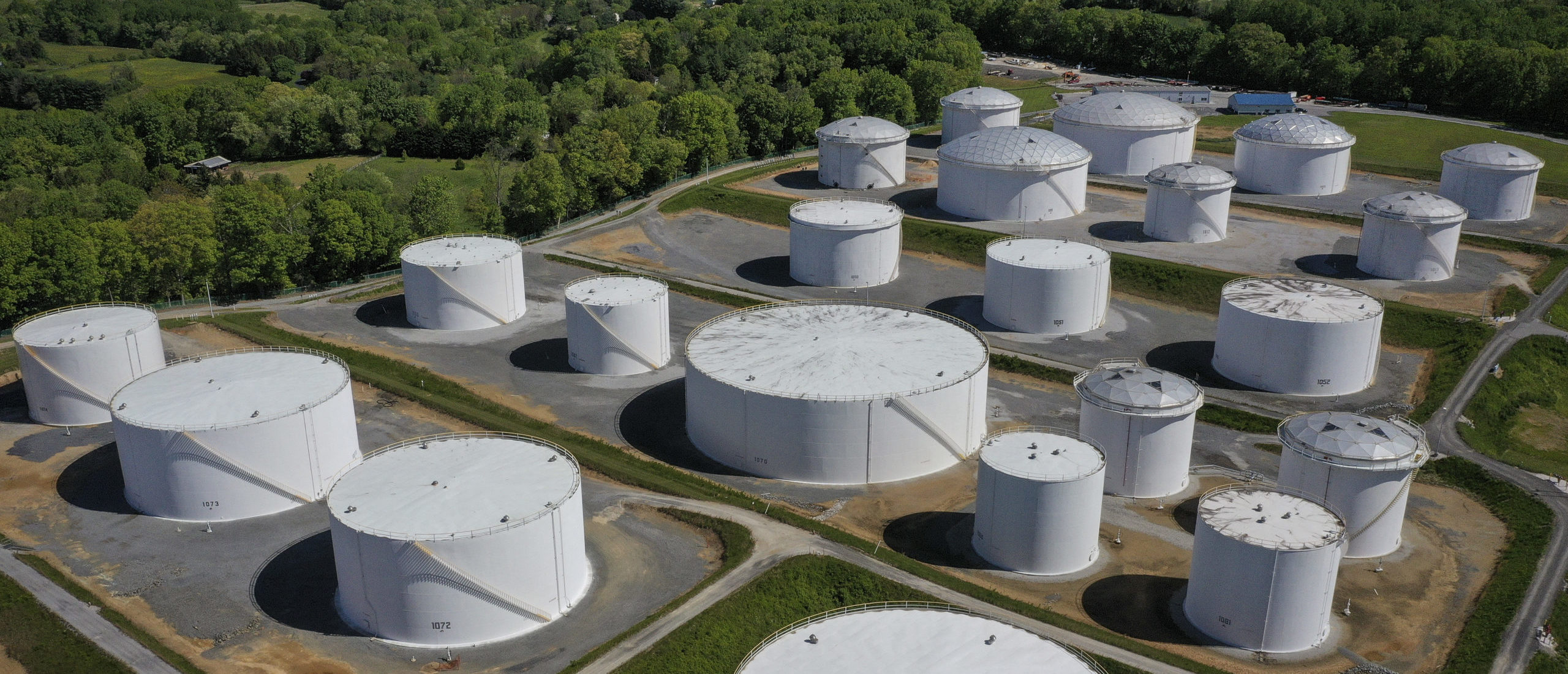 In an aerial view, fuel holding tanks are seen at Colonial Pipeline's Dorsey Junction Station on May 13, 2021 in Woodbine, Maryland. (Photo by Drew Angerer/Getty Images)