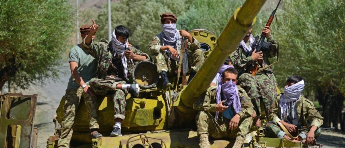 TOPSHOT - Afghan resistance movement and anti-Taliban uprising forces are pictured on a Soviet-era tank as they are deployed to patrol along a road in the Astana area of Bazarak in Panjshir province on August 27, 2021, as among the pockets of resistance against the Taliban following their takeover of Afghanistan, the biggest is in the Panjshir Valley. (Photo by AHMAD SAHEL ARMAN/AFP via Getty Images)